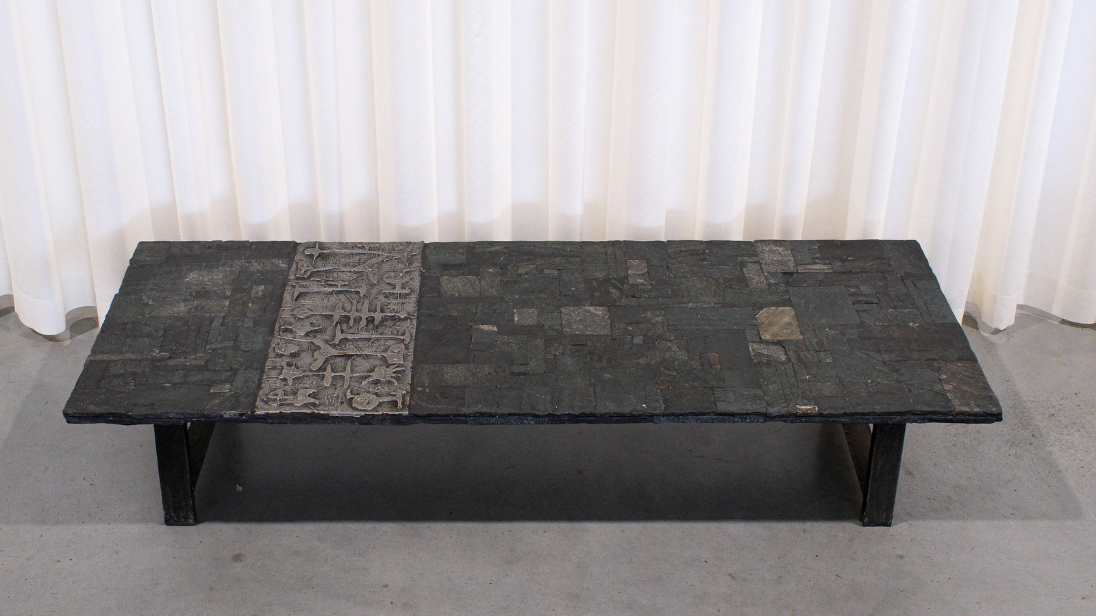 Pia MANU (XX) A vintage coffee table of slate stone and aluminium decorated with figures: Pia MANU (XX). A vintage coffee table of slate stone and aluminium decorated with figures and steel frame. Marked and circa 1960–1970s. H: 30 × W: 150 × D: 60 cm