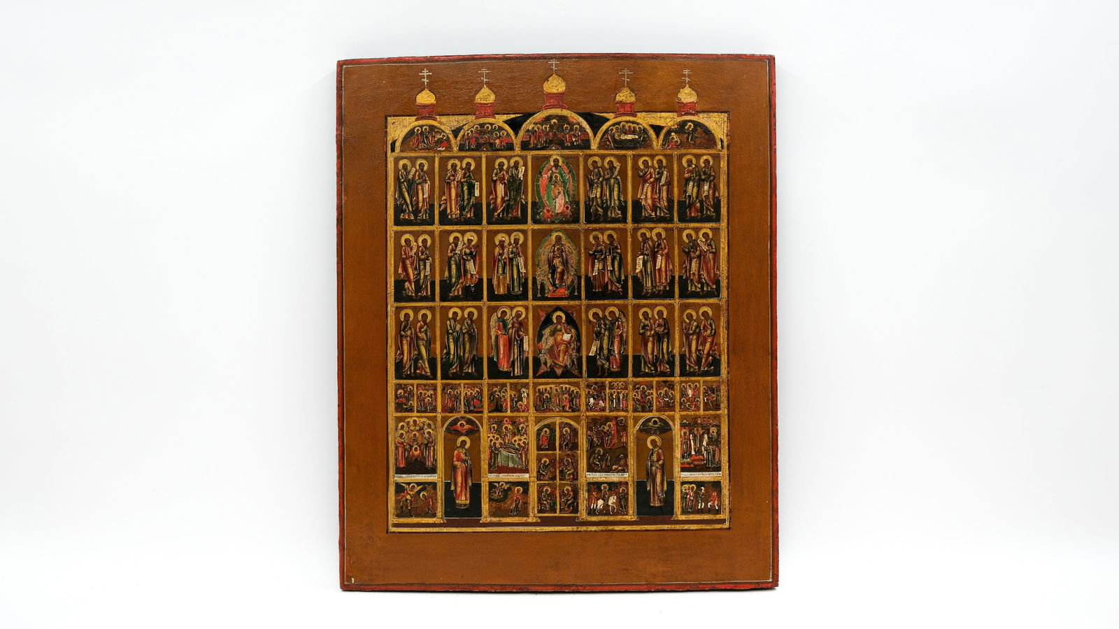 A large and antique Russian tempera on wood icon depicting a multi-tiered church festival and saints (1 of 5)