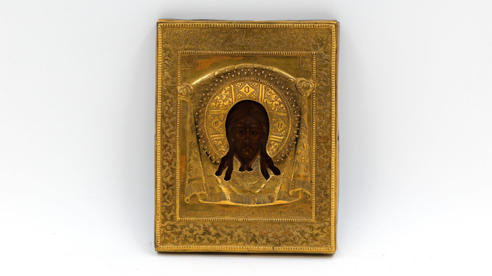 A small and antique Russian tempera on wood icon of the Mandylion with gilt brass oklad (1 of 8)