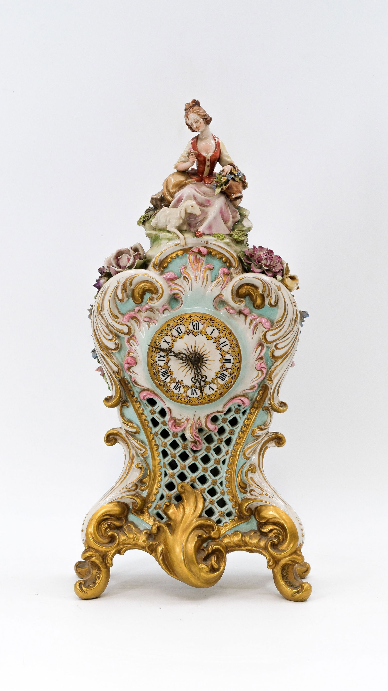 A 20th century Italian Capodimonte Rococo style glazed porcelain mantel clock: A 20th century Italian Capodimonte Rococo style glazed porcelain mantel clock, decorated with a figure of a lady on top.Circa 1970s.H: 46.5 cm
