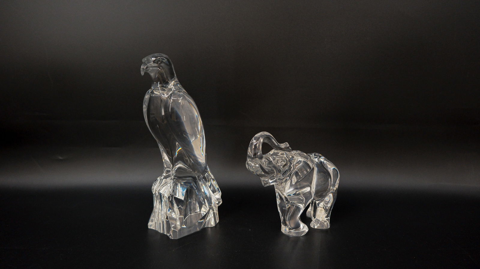 A lot of two French Baccarat clear crystal figurines of an elephant and an eagle (1 of 9)