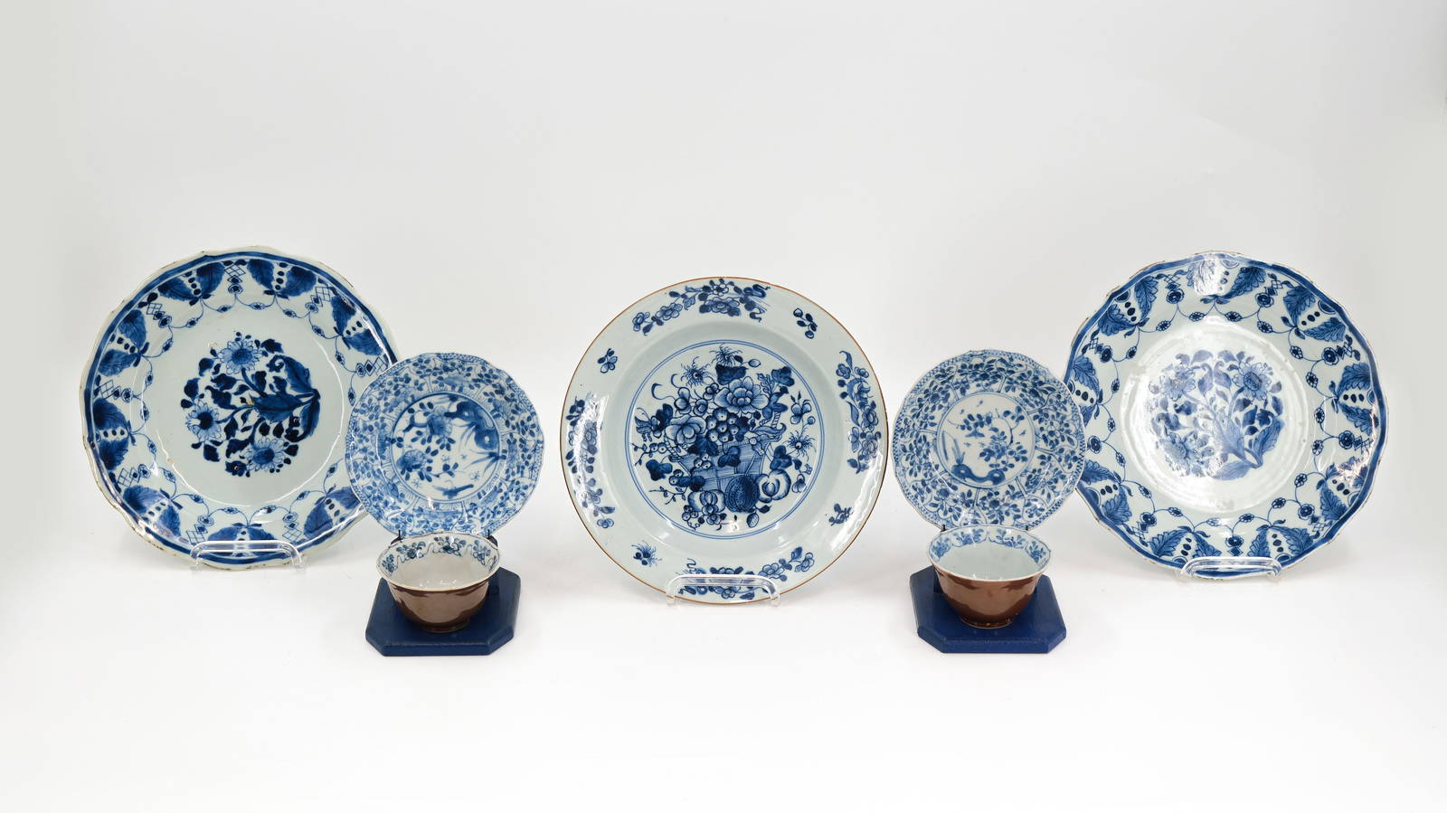 A lot of three Chinese blue and white flora decorated plates, and two small cups and underplates