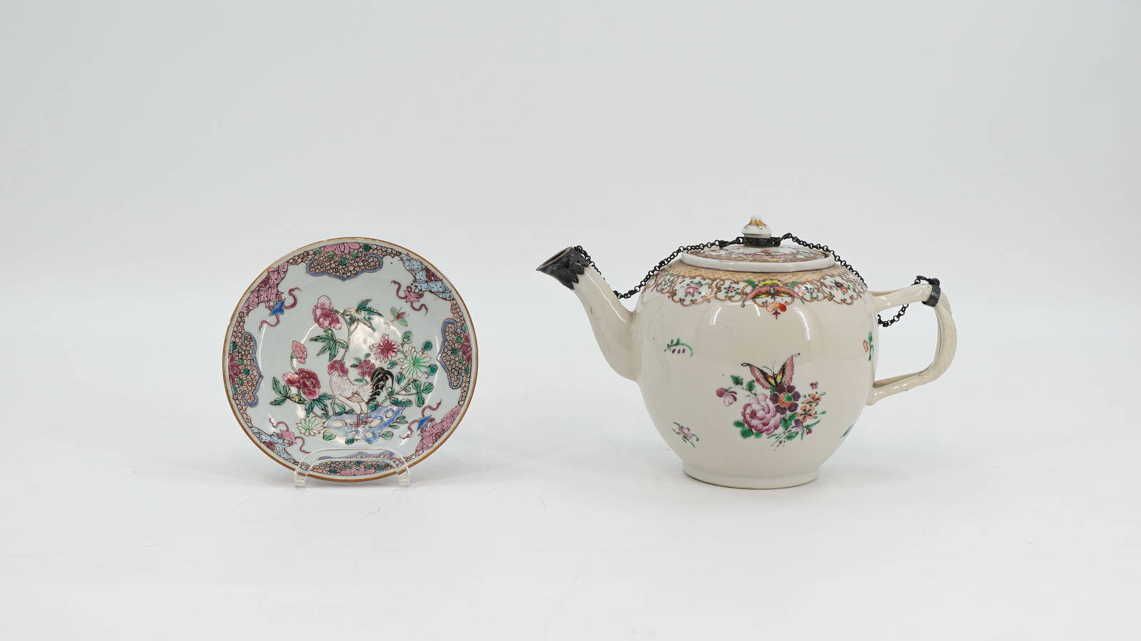 A small Chinese Famille rose chicken and flora decorated porcelain dish and a flora decorated teapot