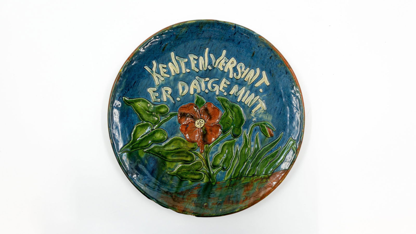 A Flemish earthenware decorated wall plate marked with pelican, for Maes of Gand: A Flemish earthenware decorated wall plate marked with pelican, for Maes of Gand. Circa 1920s. W: 33 cm