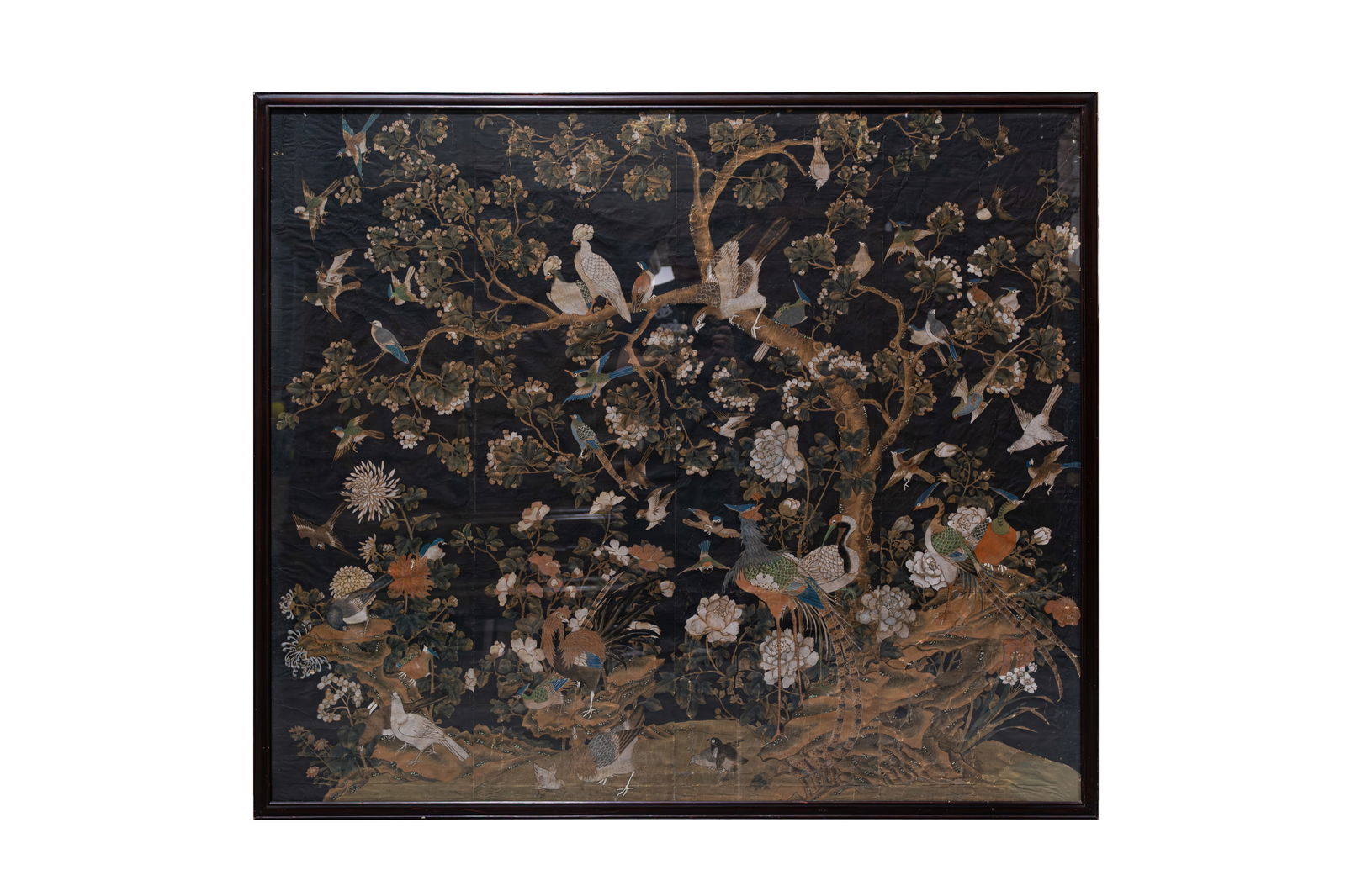 A large Chinese pastel/watercolor on canvas painting depicting a richly decorated nature scene: A large Chinese pastel/watercolor on canvas painting depicting a richly decorated nature scene with multiple birds and branches. Wood framed and glass protected. 19th century. H: 139 - W: 161 cm