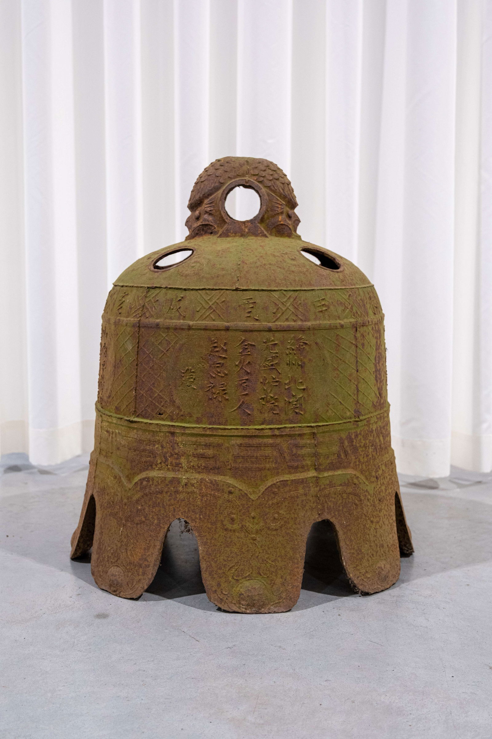 A large Chinese cast iron temple bell with calligraphy: A large Chinese cast iron temple bell with calligraphy. 20th century. H: 66 - W: 56 cm