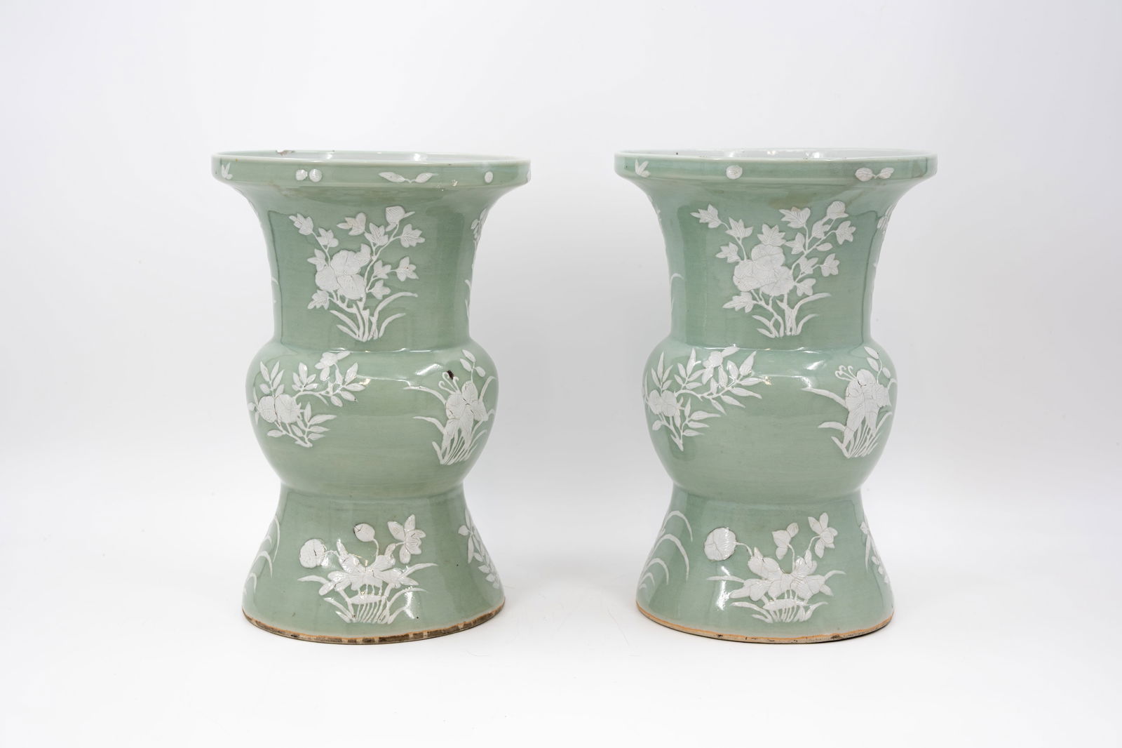 A lot of two Chinese white vases decorated with flora and branches on a celadon background: A lot of two Chinese white vases decorated with flora and branches on a celadon background. 19th/20th century. H: 32,5 cm Condition: one rim chip, otherwise vase in excellent condition. Report avail