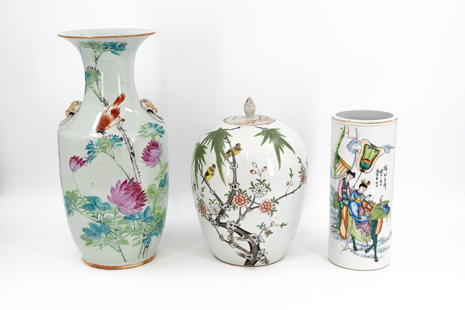 A lot of three Chinese Qianjiang and famille rose variously decorated porcelain vases: A lot of three Chinese Qianjiang and famille rose variously decorated porcelain vases. Consisting of: one decor of birds and peonies, one covered ginger vase with a decor of birds on branches, one cyl