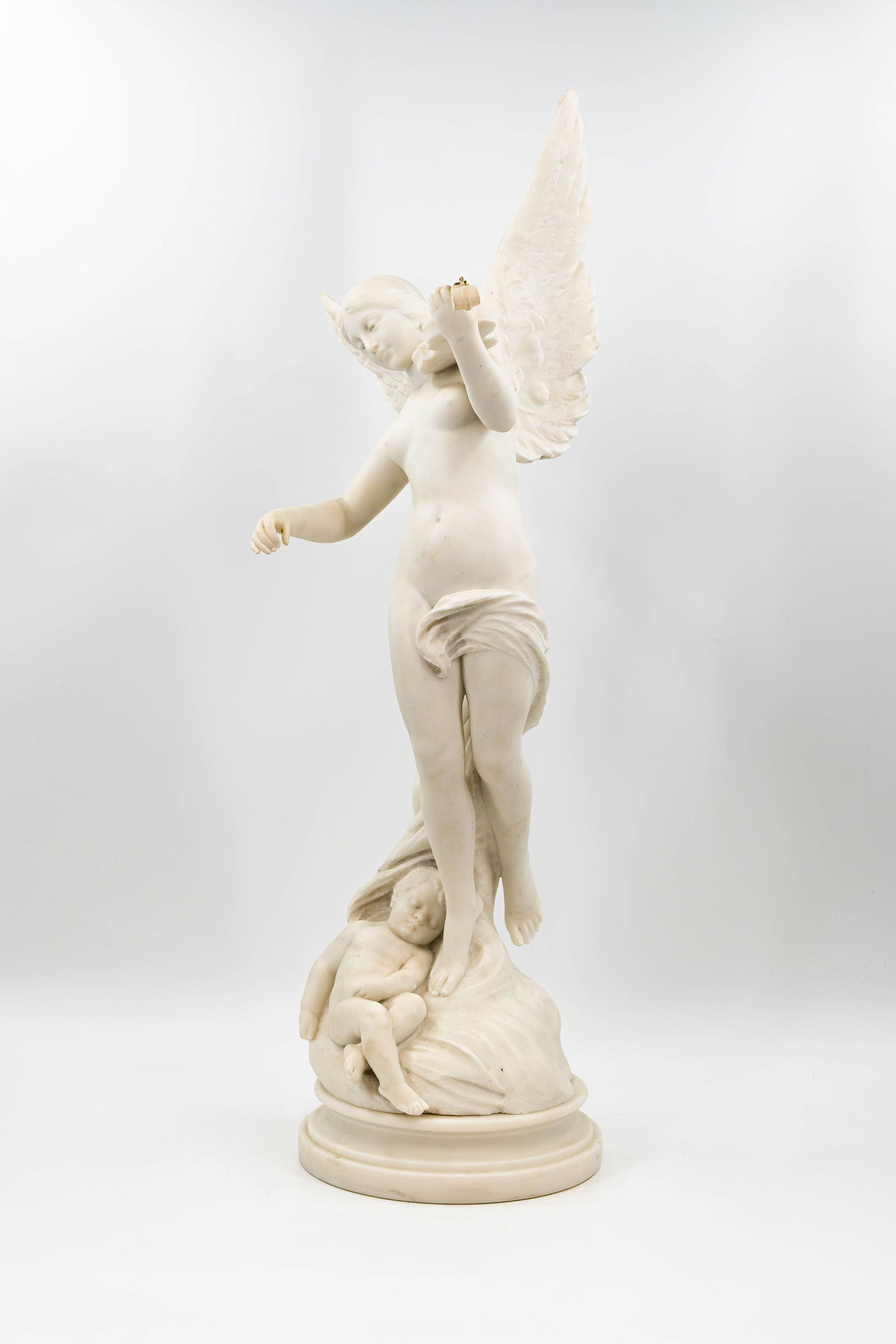 An antique carved white marble sculpture of a winged lady playing a violin with a resting child (1 of 8)