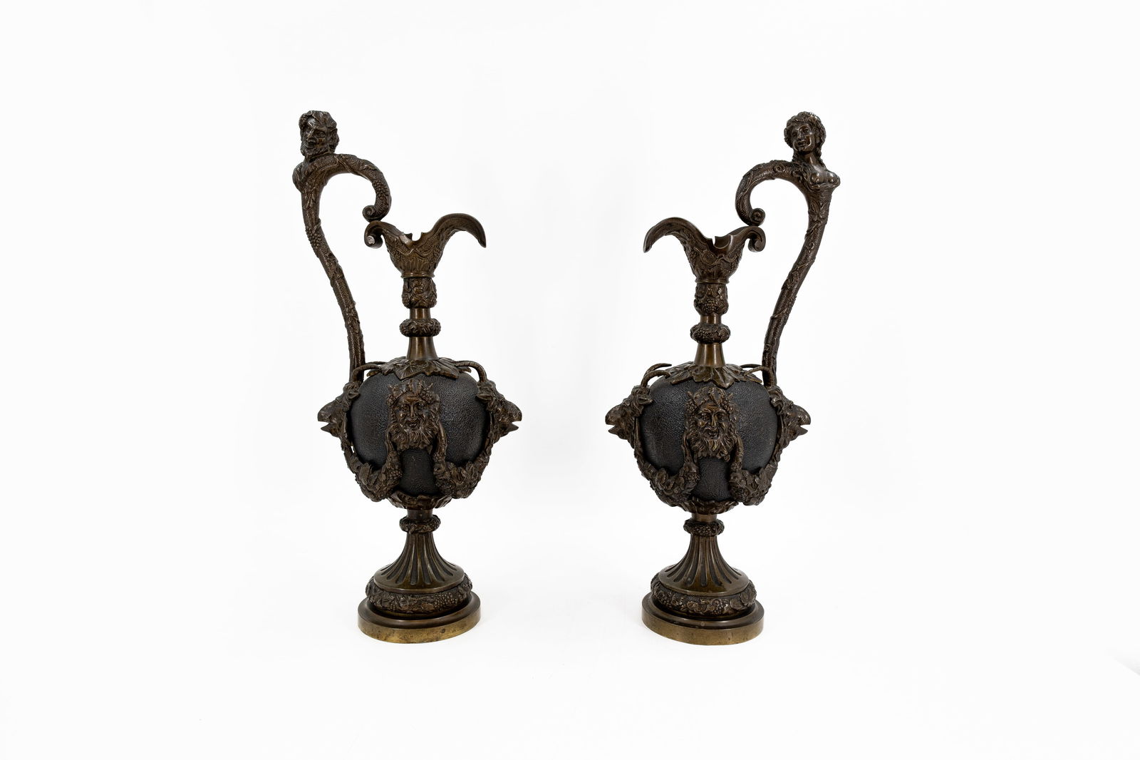 A pair antique baroque style richly decorated patinated bronze ewer vases with handle: A pair antique baroque style richly decorated patinated bronze ewer vases with handle. Late 19th century. H: 54 cm