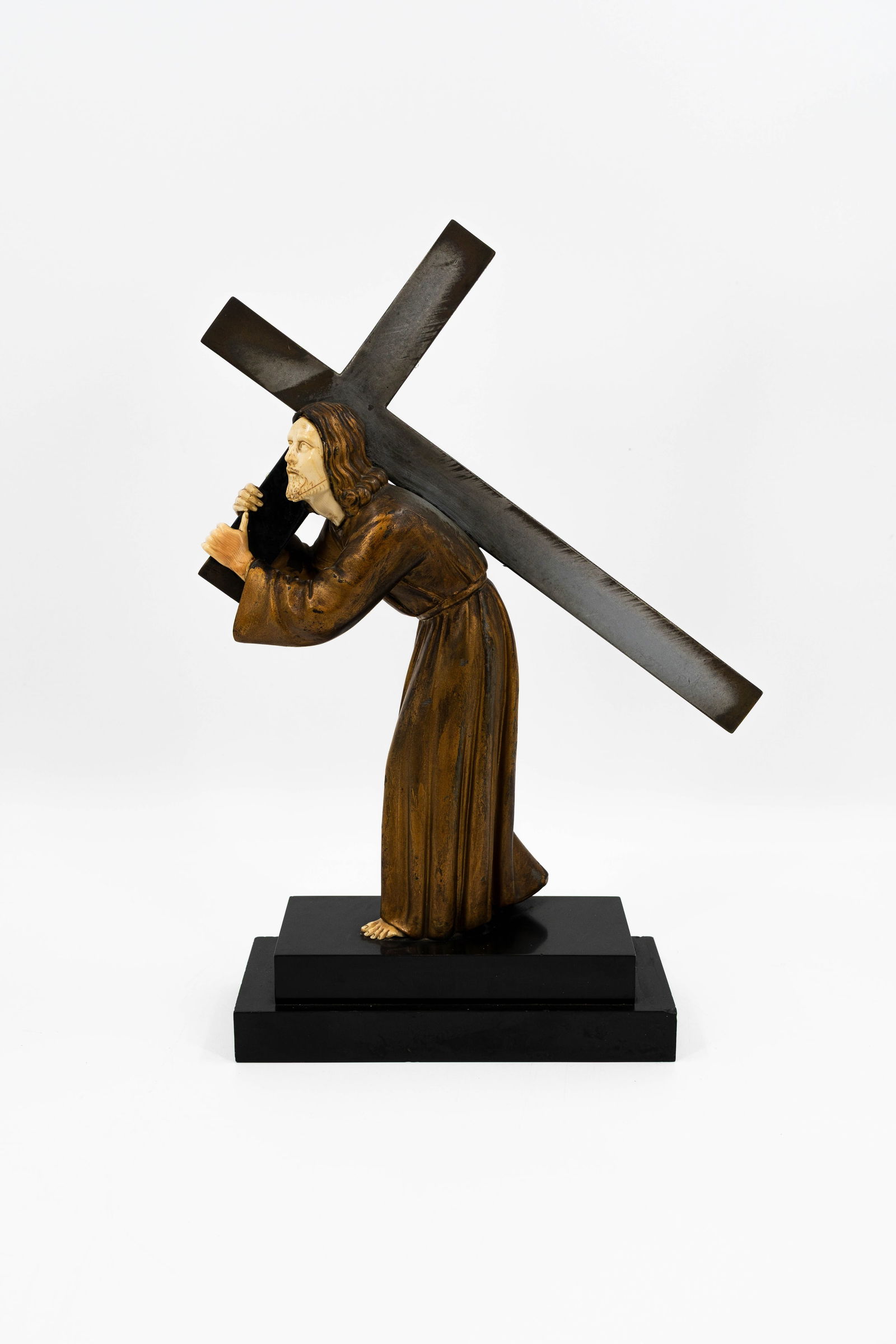 An antique patinated spelter and resine figural sculpture depicting Christ with the cross (1 of 5)