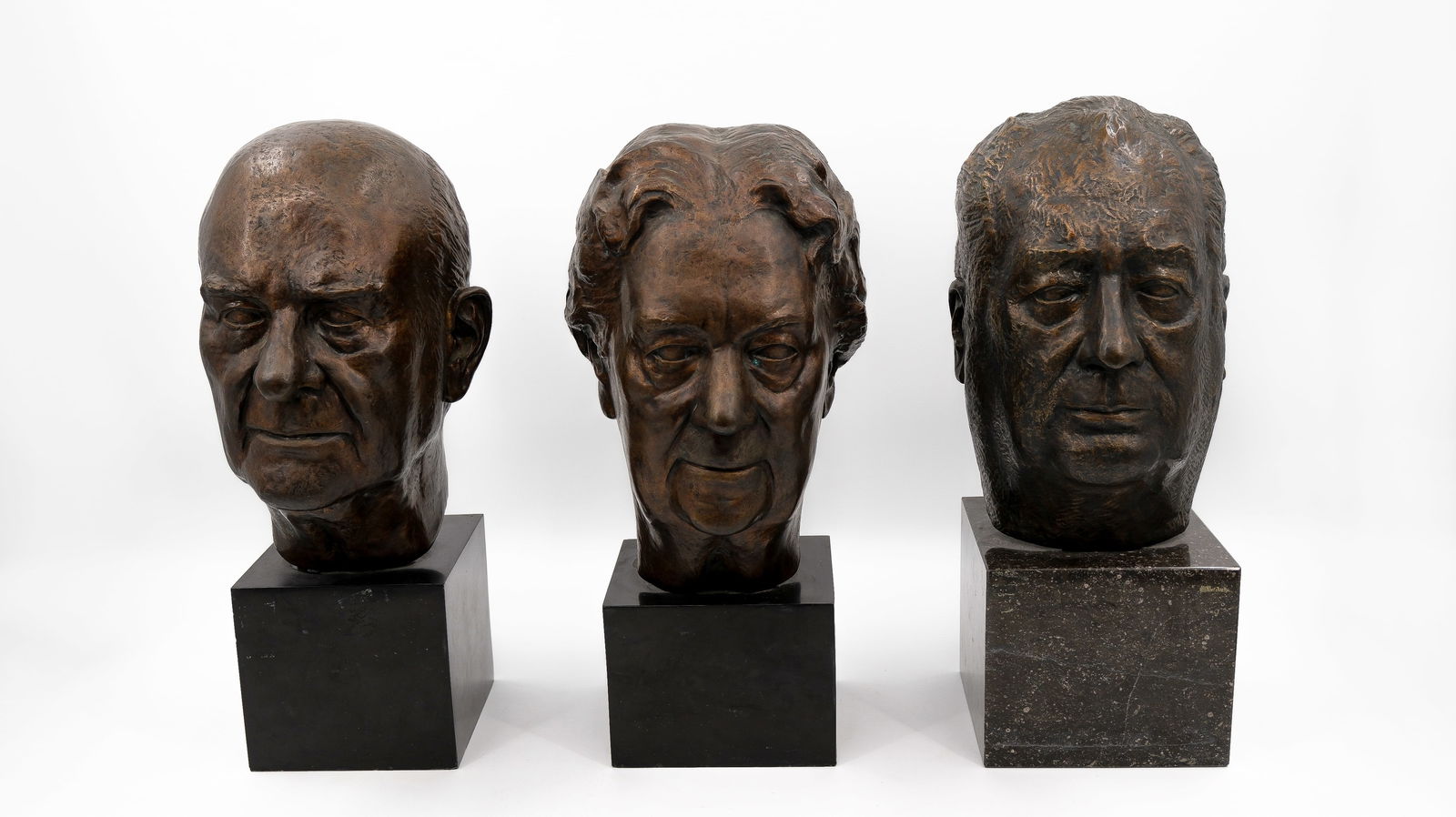 A lot of three patinated bronze bust sculptures: A lot of three patinated bronze bust sculptures. All mounted on a black marble base. One represents Lionel Van den Bossche. Signed J.De Dyn. First half 20th century. H: 45 - 45,5 - 46,5 cm