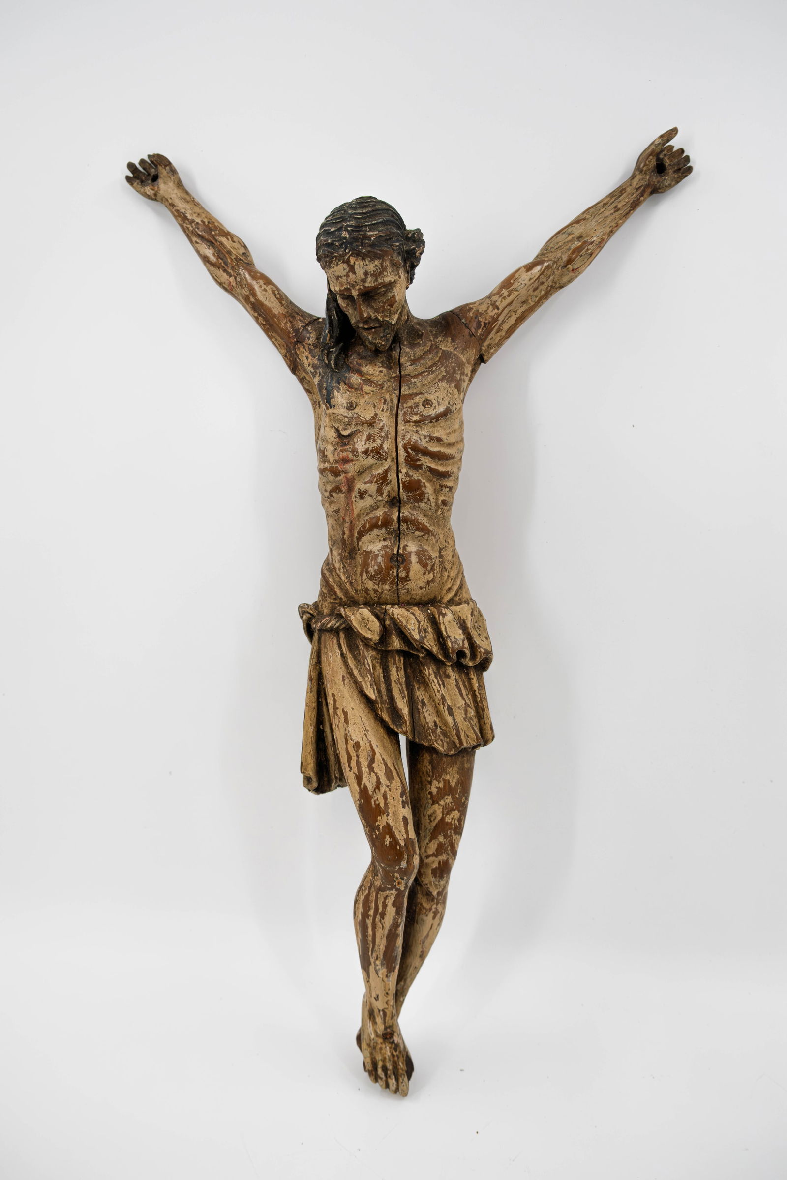 An antique polychrome patinated carved wood corpus sculpture of Christ (1 of 3)