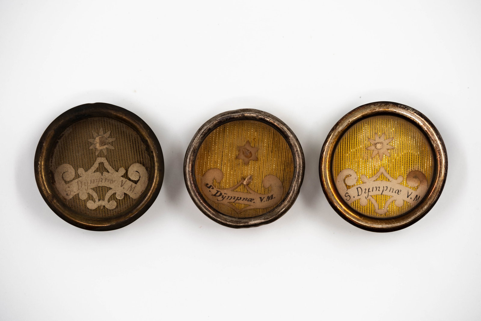 A lot of three sealed thecas containing relics of Saint Dymphna, with a Certificate of Authenticity: A lot of three sealed thecas containing relics of Saint Dymphna, Virgin and Martyr, with a Certificate of Authenticity. S. Dympnae VM., Saint Dymphna, Virgin and Martyr The theca and/or