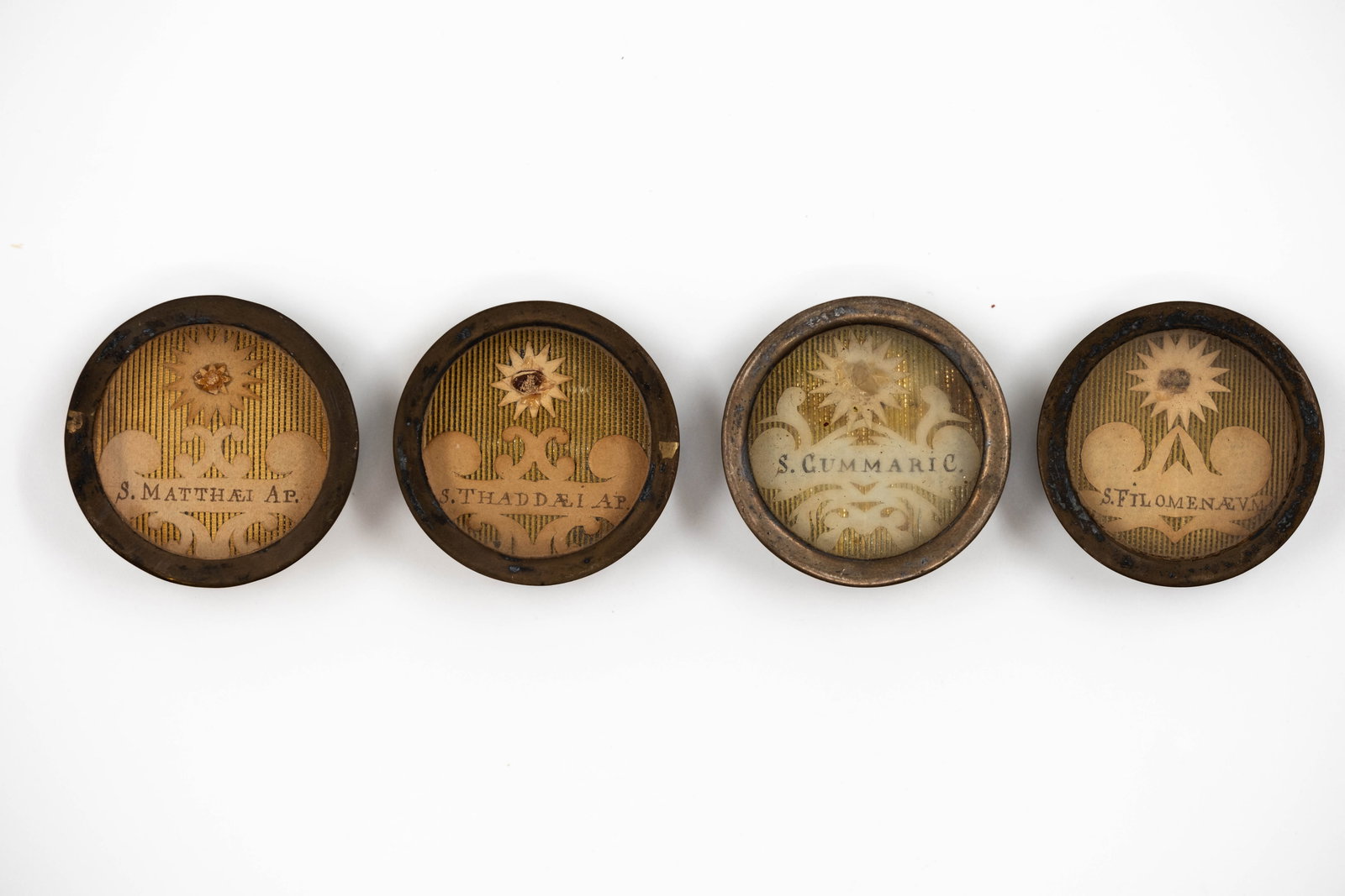 A lot of four sealed thecas containing relics of two Apostles and two Saints: A lot of four sealed thecas containing relics of Saint Thaddeus, Saint Cummaric, Saint Philomena, and Saint Matthew. S. Thaddaei Ap., Saint Thaddeus, Apostle S. Cummaric., Saint Cummaric S.
