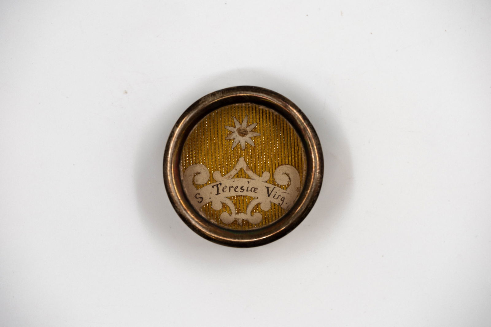 A sealed theca containing a relic of Saint Teresa, with a Certificate of Authenticity (1 of 3)