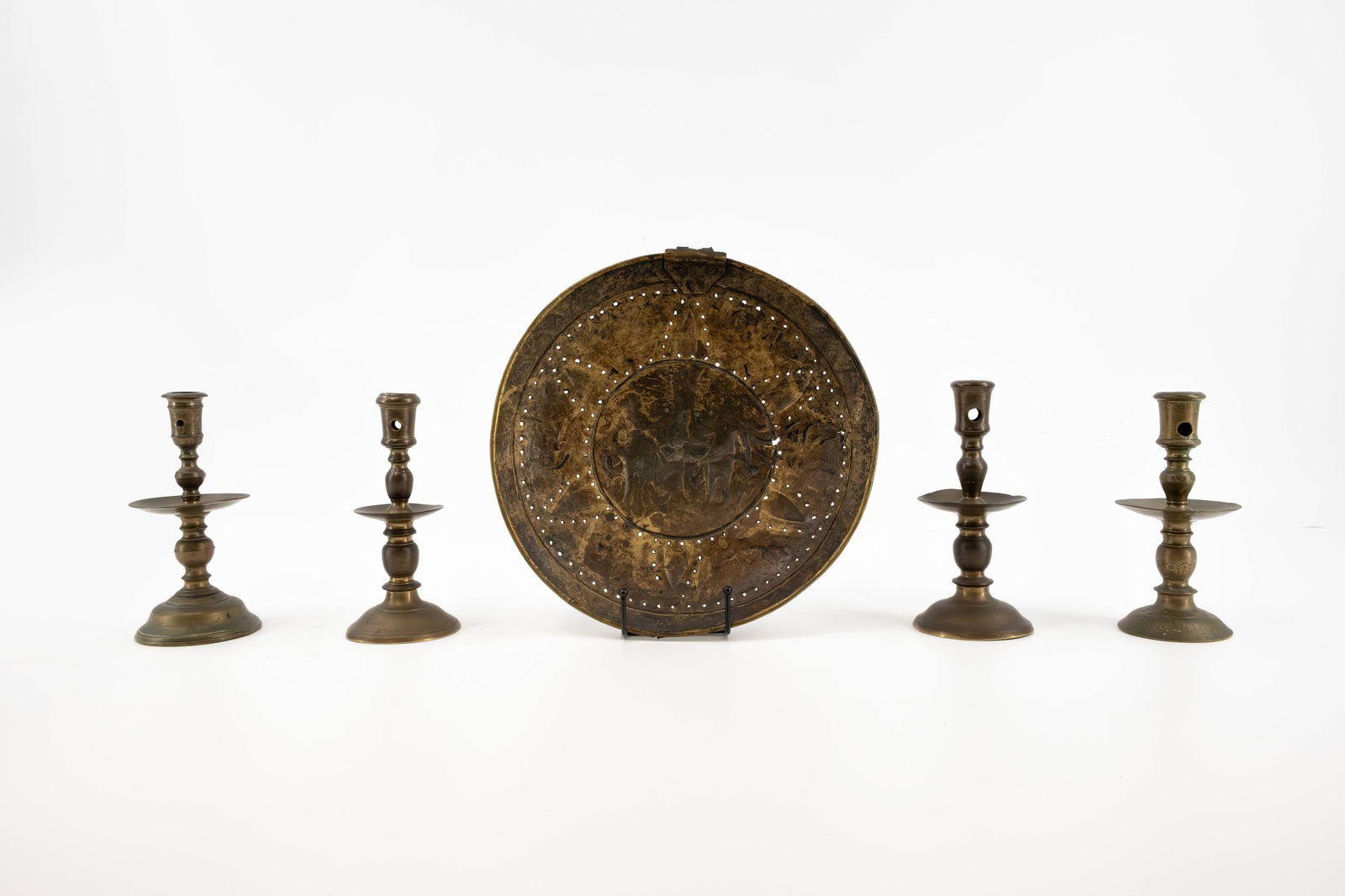 A lot of four antique copper candle holders, together with a copper religious decorated dish (1 of 8)