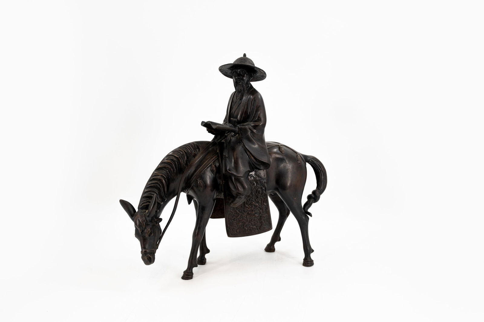 A Japanese patinated bronze sculpture depicting a wiseman on his horse: A Japanese patinated bronze sculpture depicting a wiseman on his horse. Meiji period, late 19th century. H: 45 - W: 45 cm