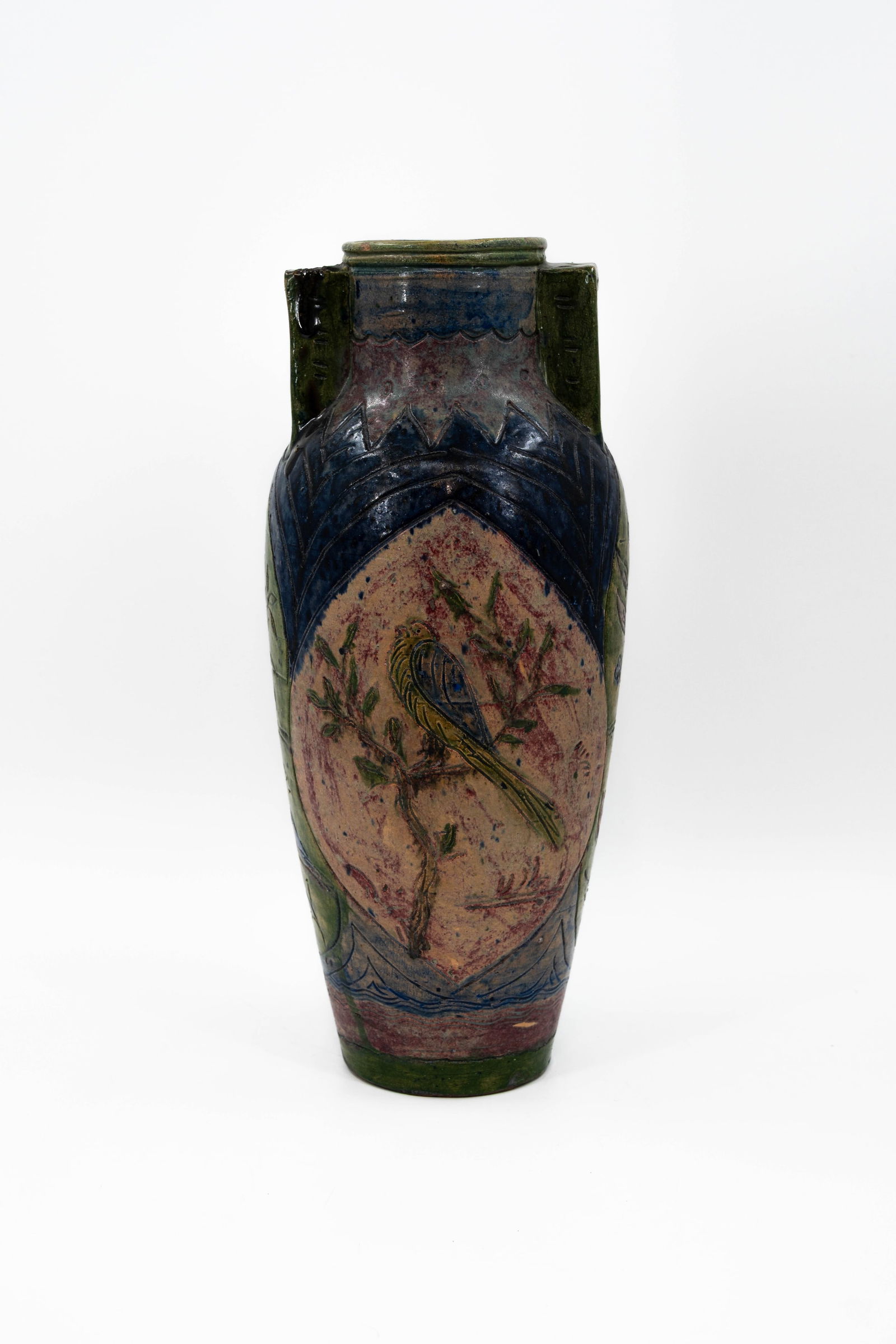 A Flemish Bredene earthenware vase decorated with a bird on a branch: A Flemish Bredene earthenware vase decorated with a bird on a branch. 19th/20th century. H: 44,5 cm