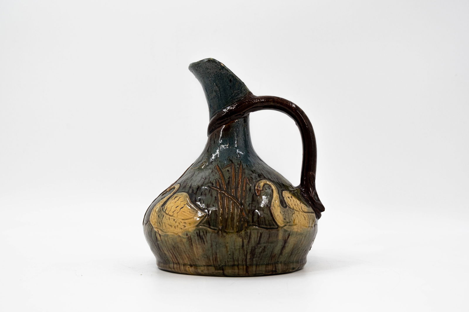 An antique Belgian Torhout swan decorated earthenware vase with handle: An antique Belgian Torhout swan decorated earthenware vase with handle. Unsigned, first half 20th century. H: 21 cm