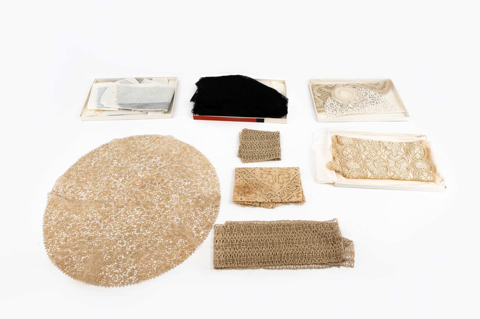 A collection of variously shaped and finely decorated needle laceworks: A collection of eight variously shaped and finely decorated needle laceworks. Belgian made, 18th/20th century. W: 61 cm, largest