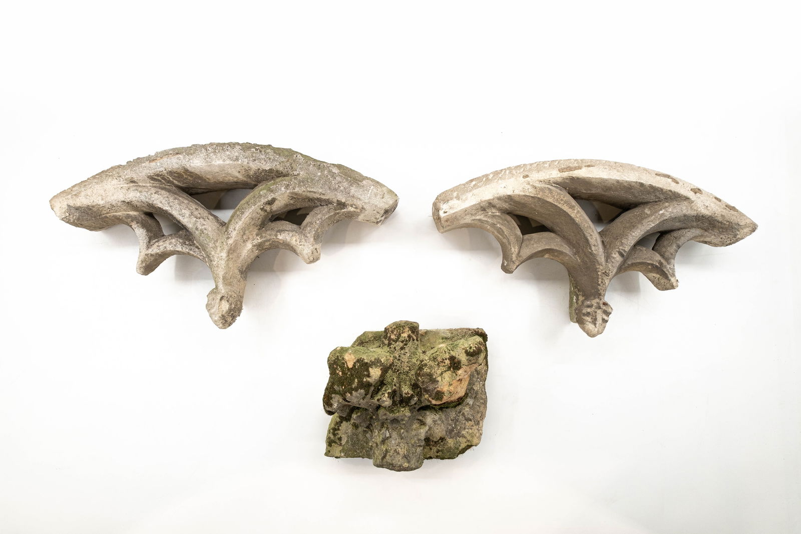 A lot of three antique Neo-gothic stone variously shaped church fragment ornaments: A lot of three antique Neo-gothic stone variously shaped church fragment ornaments. 18th/19th century. H: 25 - W: 30 cm H: 37 - W: 67 cm
