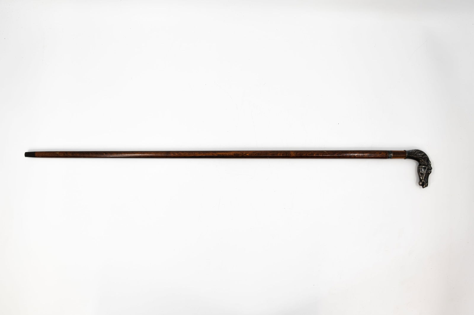 An antique silver mounted wooden walking stick decorated with a horse head shaped handle: An antique silver mounted wooden walking stick with hidden knife inside, decorated with a horse head shaped handle. 19th/20th century. L: 92 cm