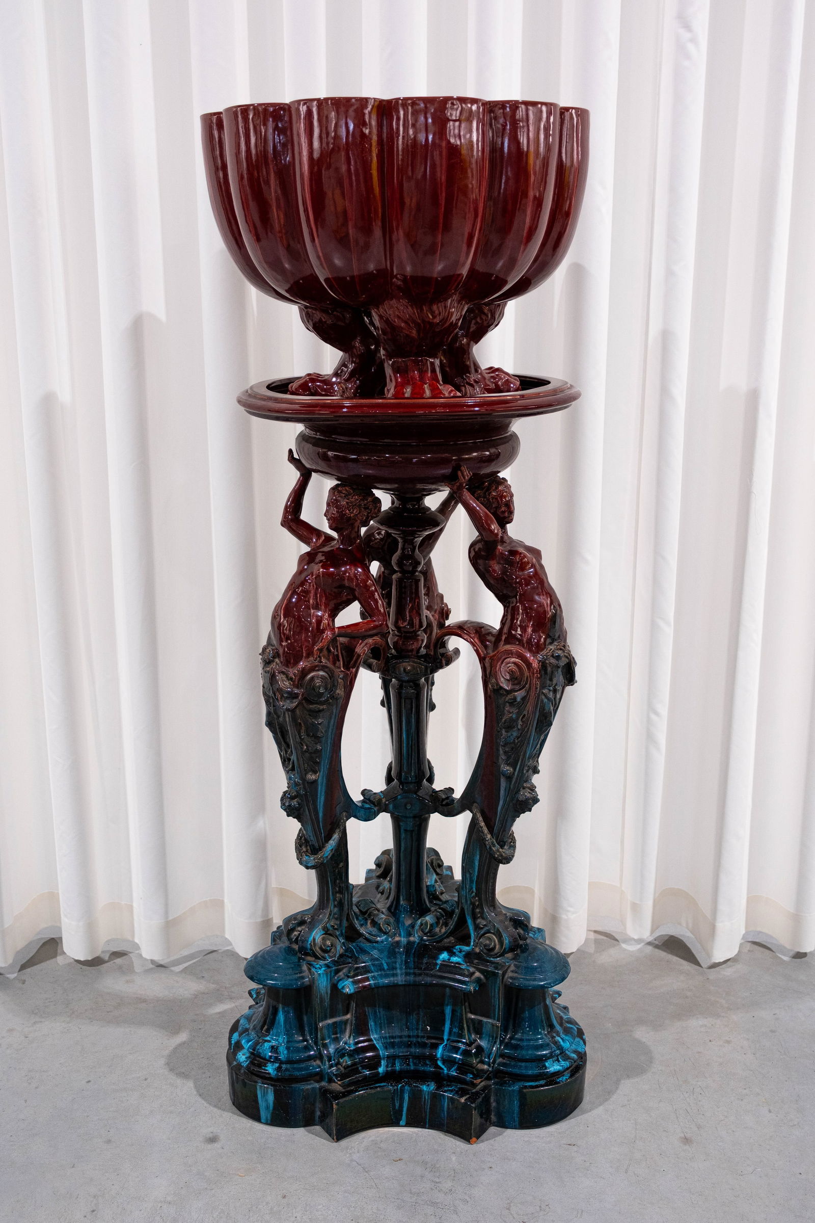 An imposing and antique French Majolica glazed ceramic jardiniere on figural matching stand: An imposing and antique French Majolica glazed ceramic jardiniere on matching stand with three figures of ladies holding the top. Circa 1900. H: 150 cm