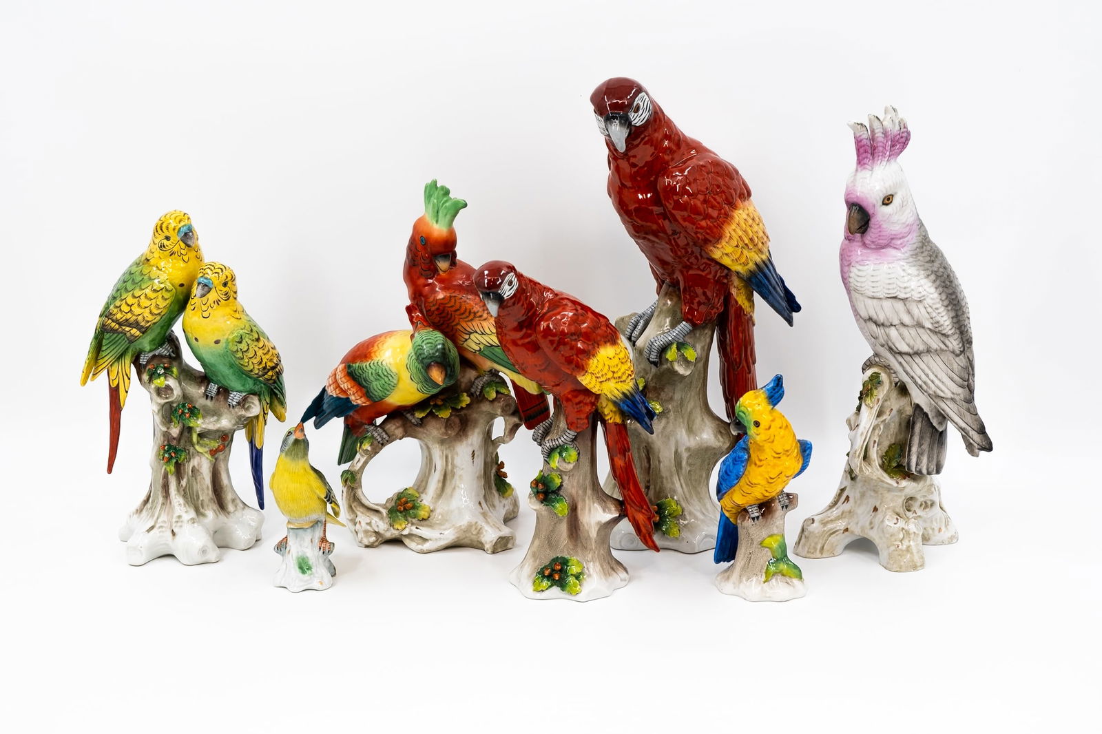 A collection of seven Napoli marked variously decorated porcelain parrots (1 of 19)