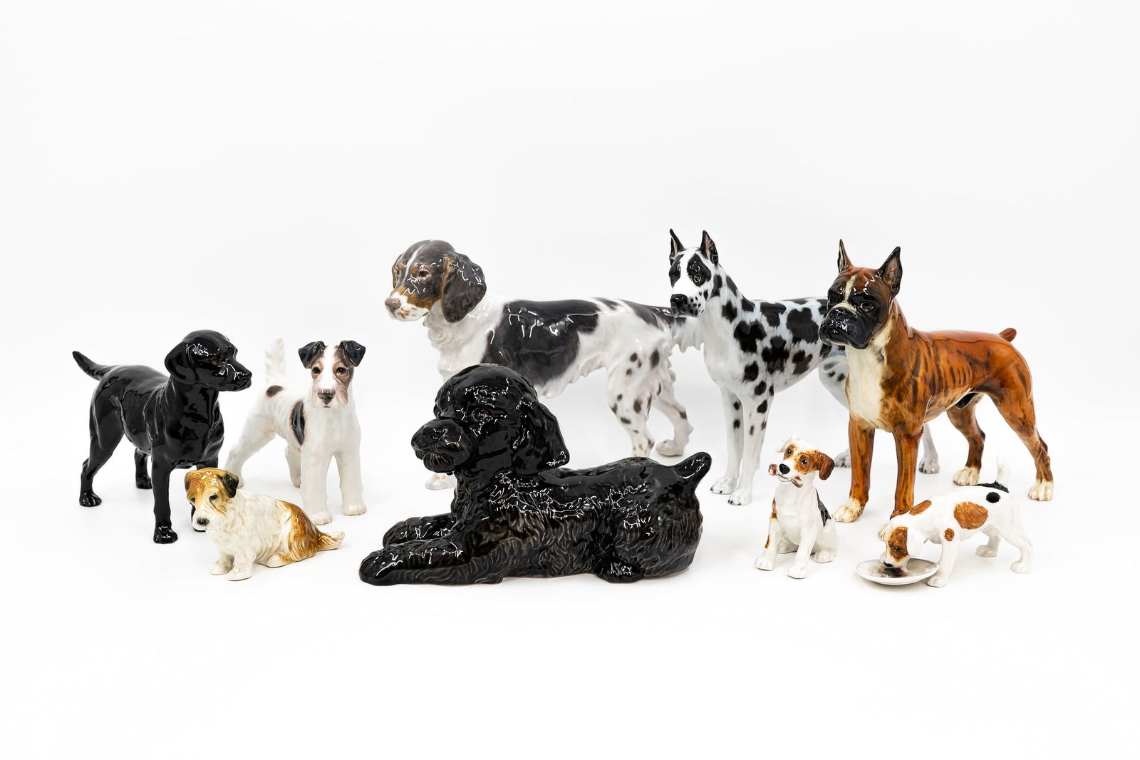 A collection of ten variously decorated porcelain figurines of dogs (1 of 20)
