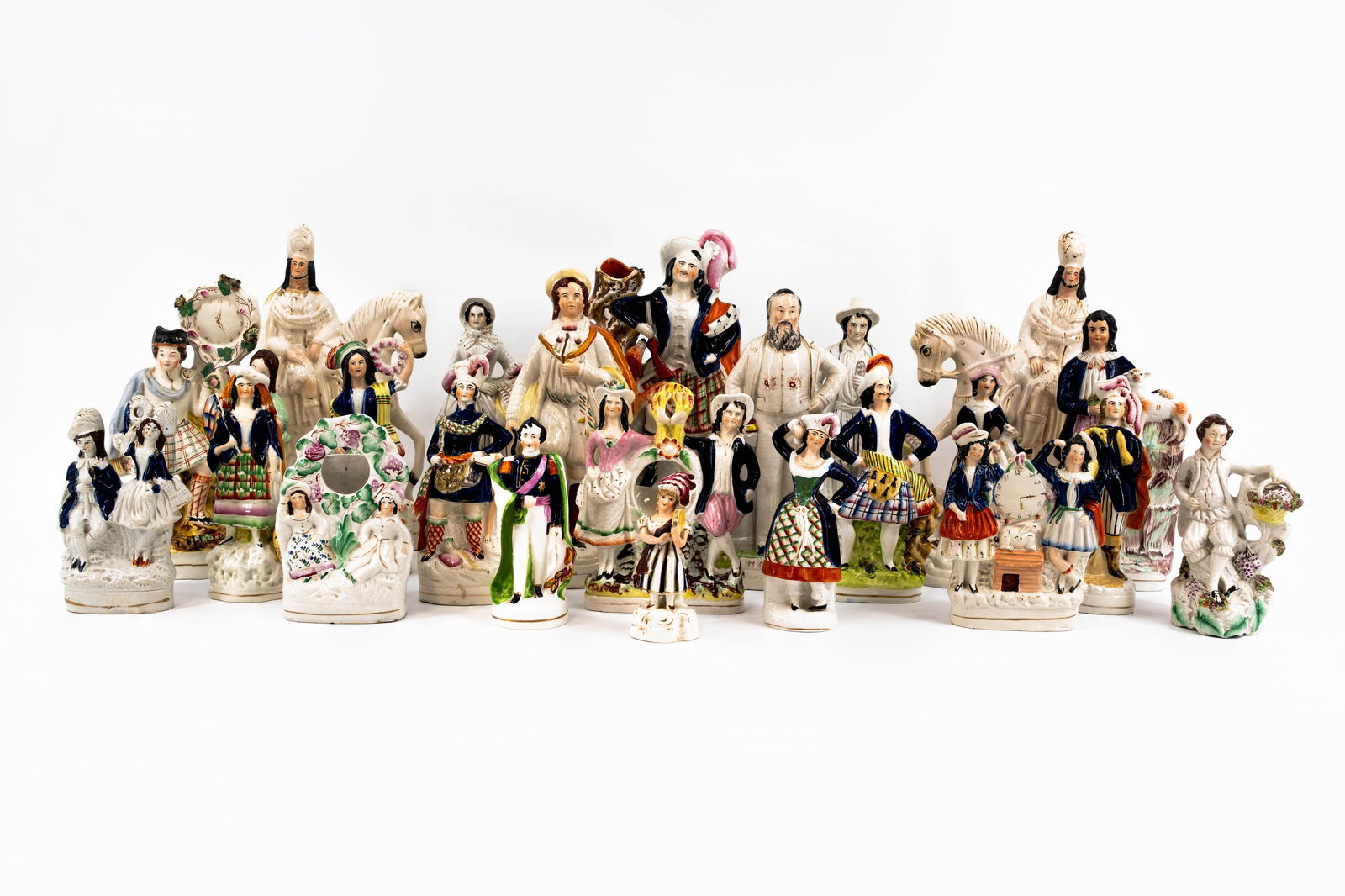 A large collection of 23 various antique English Staffordshire ceramic figures: A large collection of 23 various antique English Staffordshire ceramic figures, all differently decorated and shaped. Circa 1900-1970s. Condition: some have old damages, report available on request.