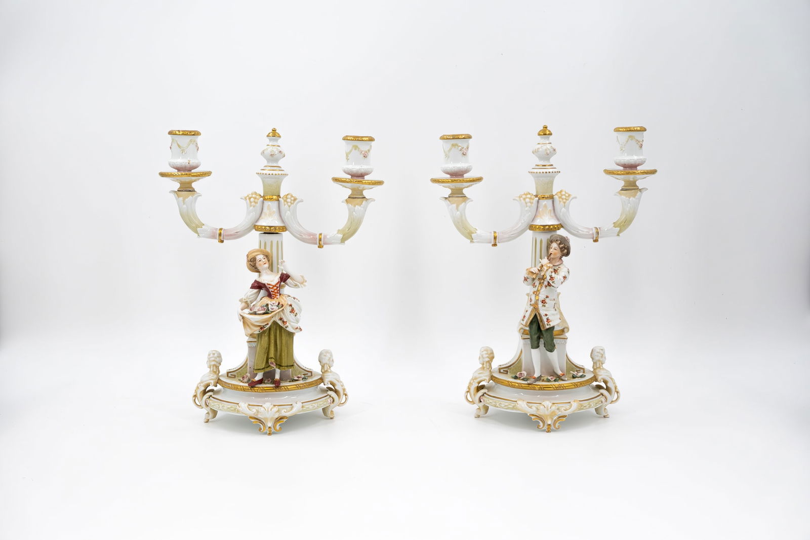 A pair of matching antique Saxony-style glazed porcelain figural decorated candle holders (1 of 8)