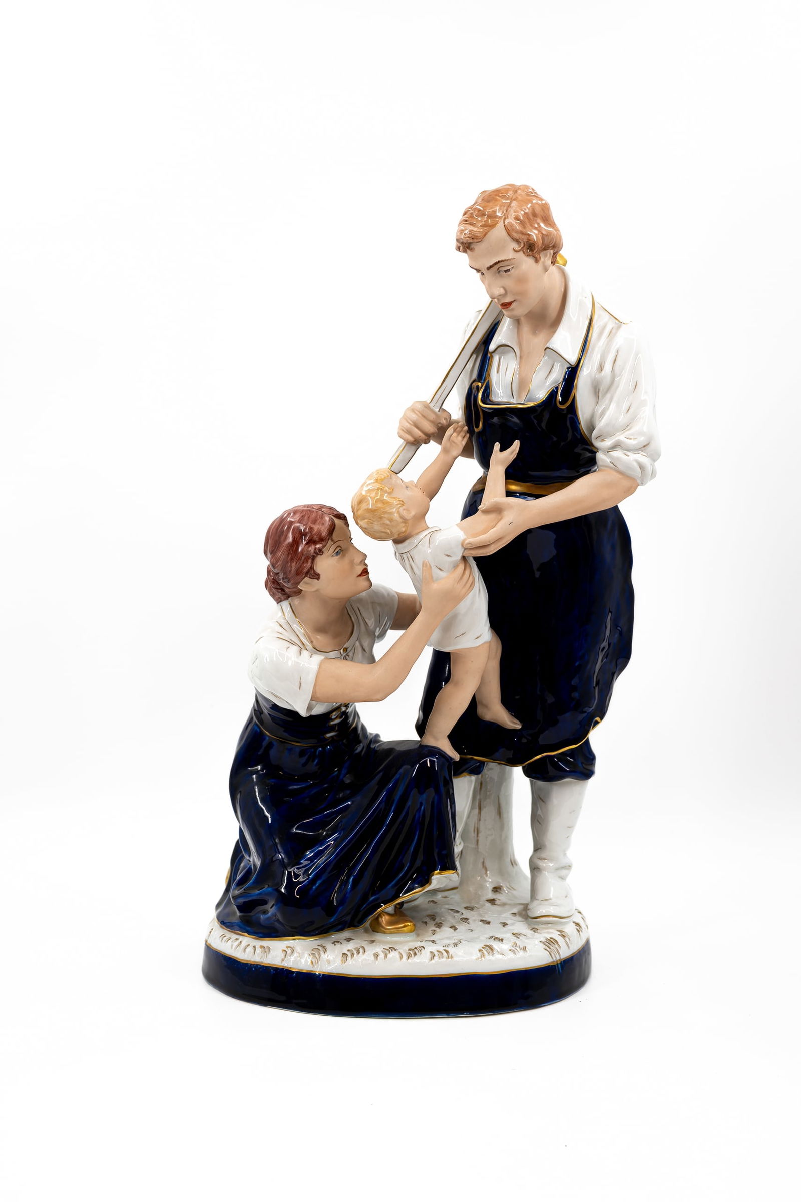 A Bohemian glazed porcelain Royal Dux figural group of a blacksmith and his family: A Bohemian glazed porcelain Royal Dux figural group of a blacksmith and his family. Marked and numbered. 20th century. H: 61 cm