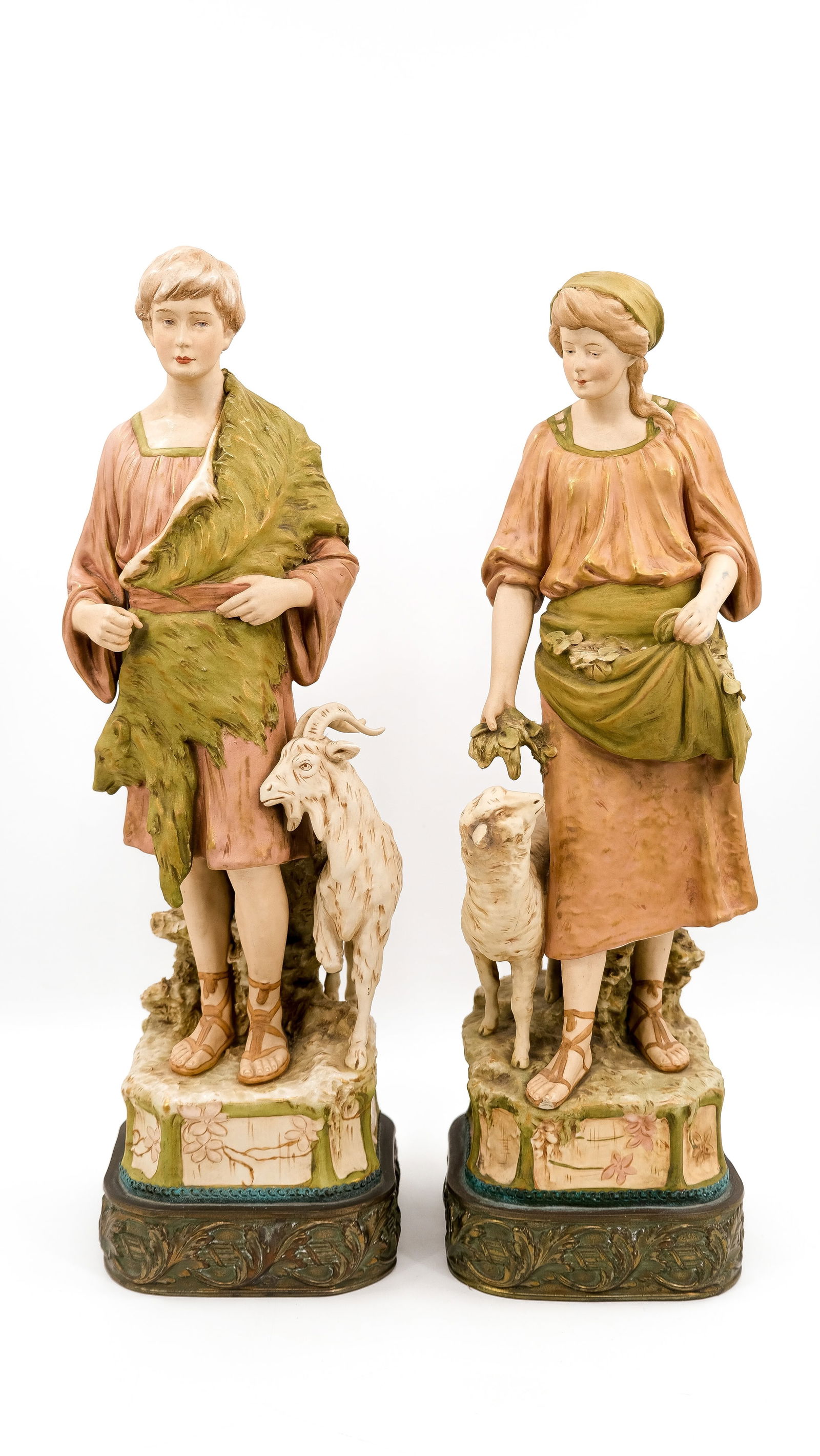 A Bohemian glazed porcelain Royal Dux figural pair of a shepherd and shepherdess: A Bohemian glazed porcelain Royal Dux figural pair of a shepherd and shepherdess. Mounted on a brass decorated base. Marked and numbered. 19th/20th century. H: 56 - 57 cm