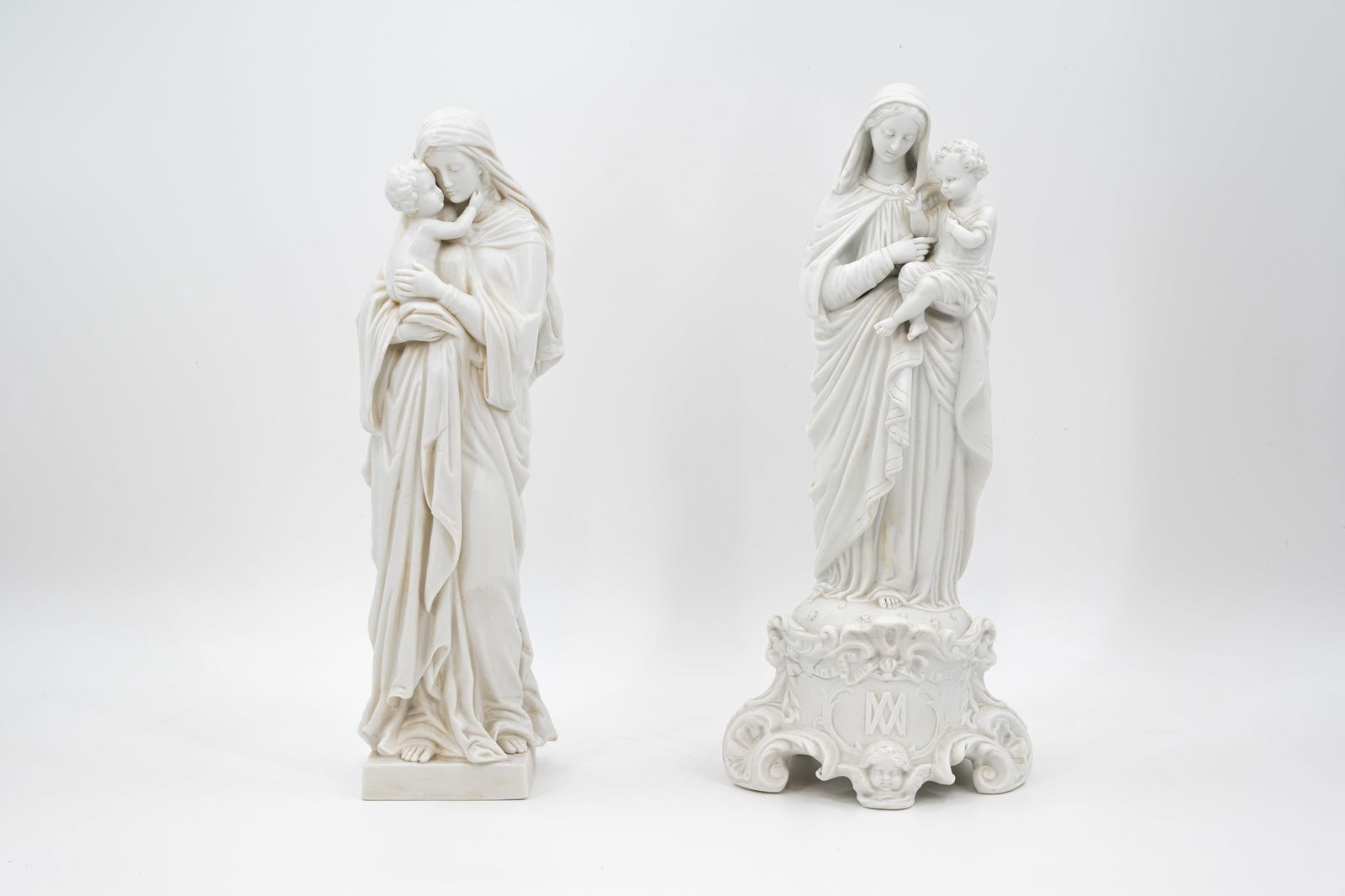 A lot of two antique unglazed white biscuit porcelain religious figures of mother and child: A lot of two antique unglazed white biscuit porcelain religious figures of mother and child. Circa 1900. H: 42 - 43 cm
