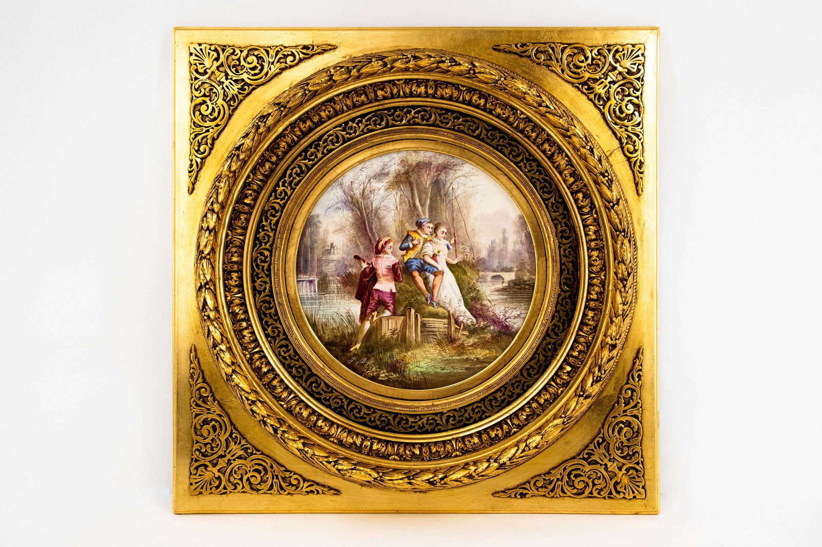 An antique French Sevres style round wall plaque decorated with a figural garden scene: An antique French Sevres style round wall plaque decorated with a figural garden scene. Mounted in a richly decorated gilded frame. Signed by J. BIGOT. Circa 1900. H: 65,5 - W: 65,5 cm, total