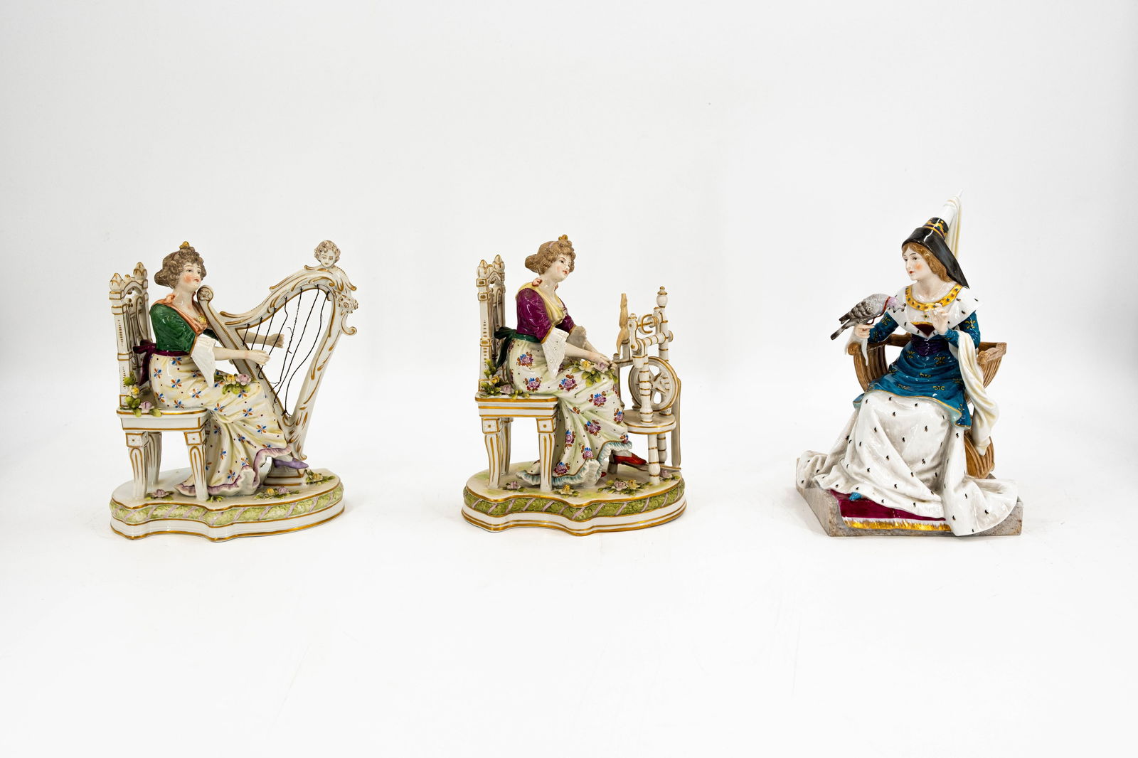 A lot of three German Sitzendorf and Passau variously decorated porcelain figures: A lot of three German Sitzendorf and Passau variously decorated porcelain figures. Consisting of: one harp playing lady, one lady as a spinner and one lady as falconer. Marked, 20th century. 