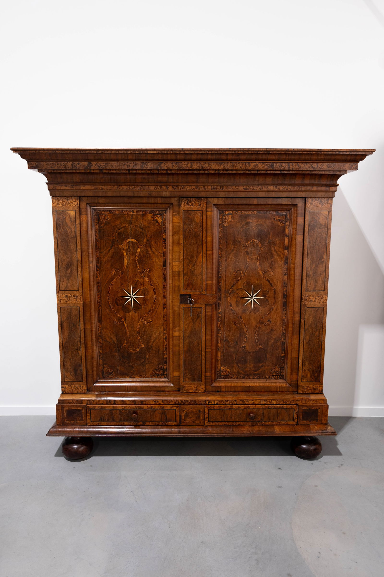 An antique German baroque walnut veneer decorated two doors wardrobe: An antique German baroque walnut veneer decorated two doors wardrobe. Dismountable, 18th century. H: 204 - W: 212 - D: 77 cm