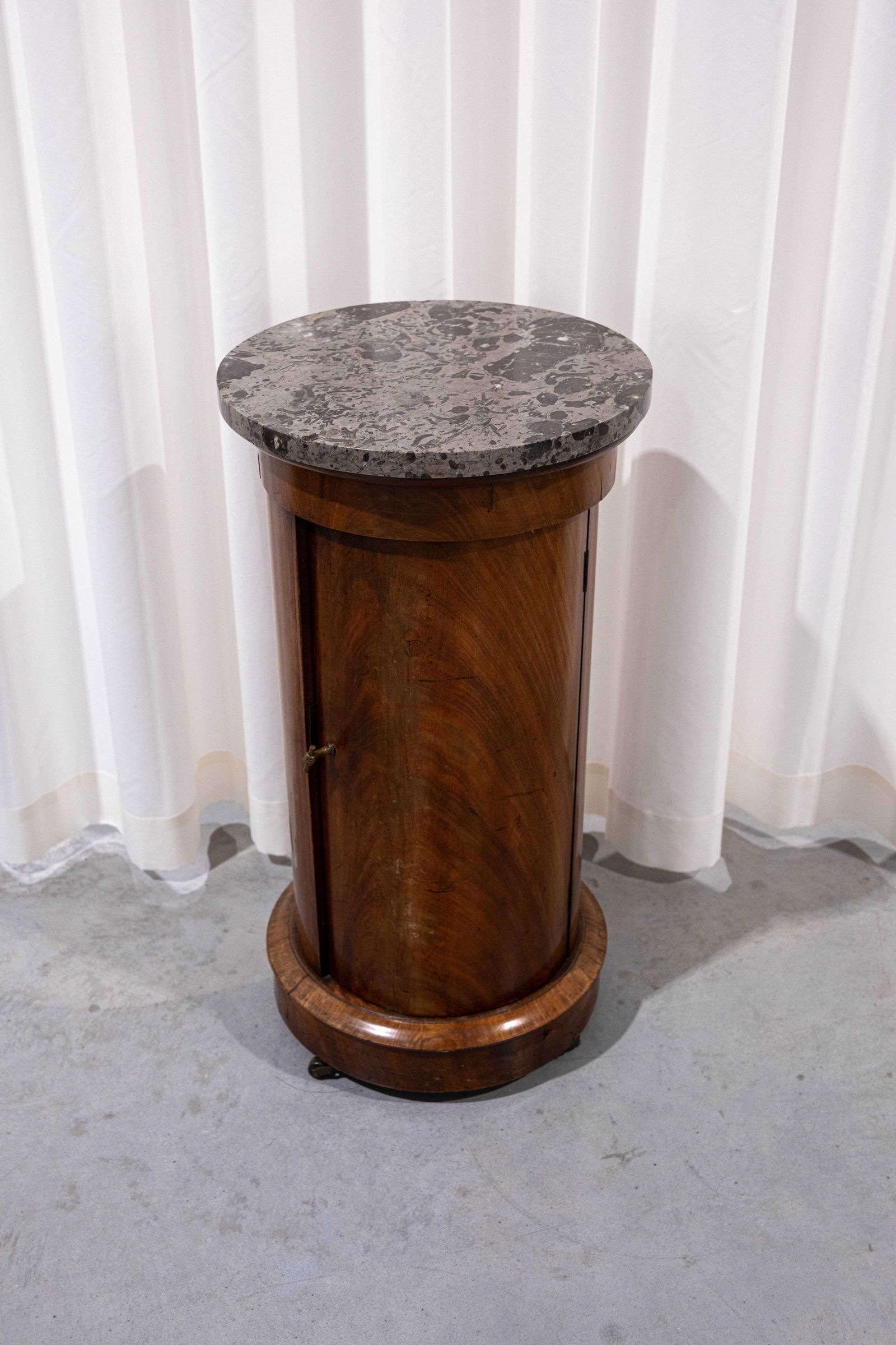 An antique French Empire cylindrical shaped mahogany wood veneer side table with a marble top (1 of 6)