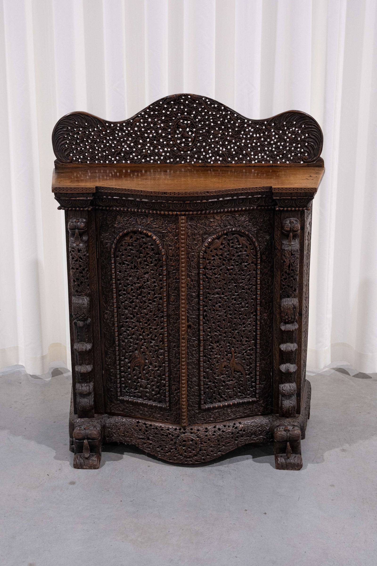 A small and antique Anglo-Indian Burmese richly carved exotic wood two-doors cabinet (1 of 7)