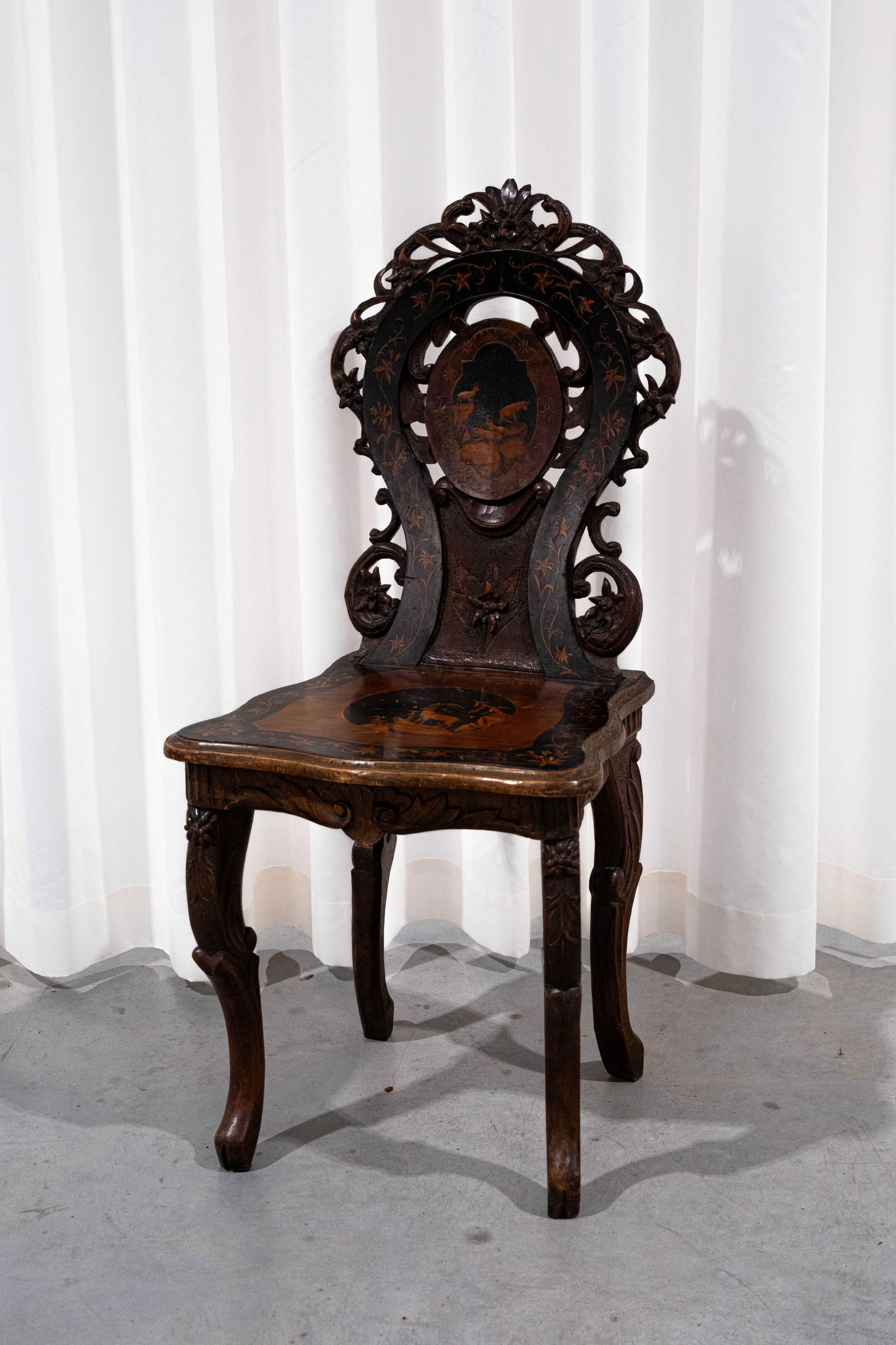 A German black forest carved wooden chair with marquetry inlay and a cylindrical music mechanism (1 of 11)