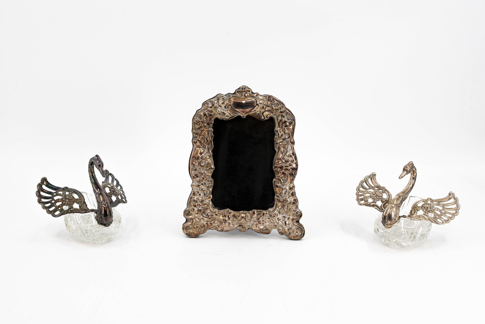 An art nouveau decorated silver mirror, together with two glass and silver swan shaped figures (1 of 14)