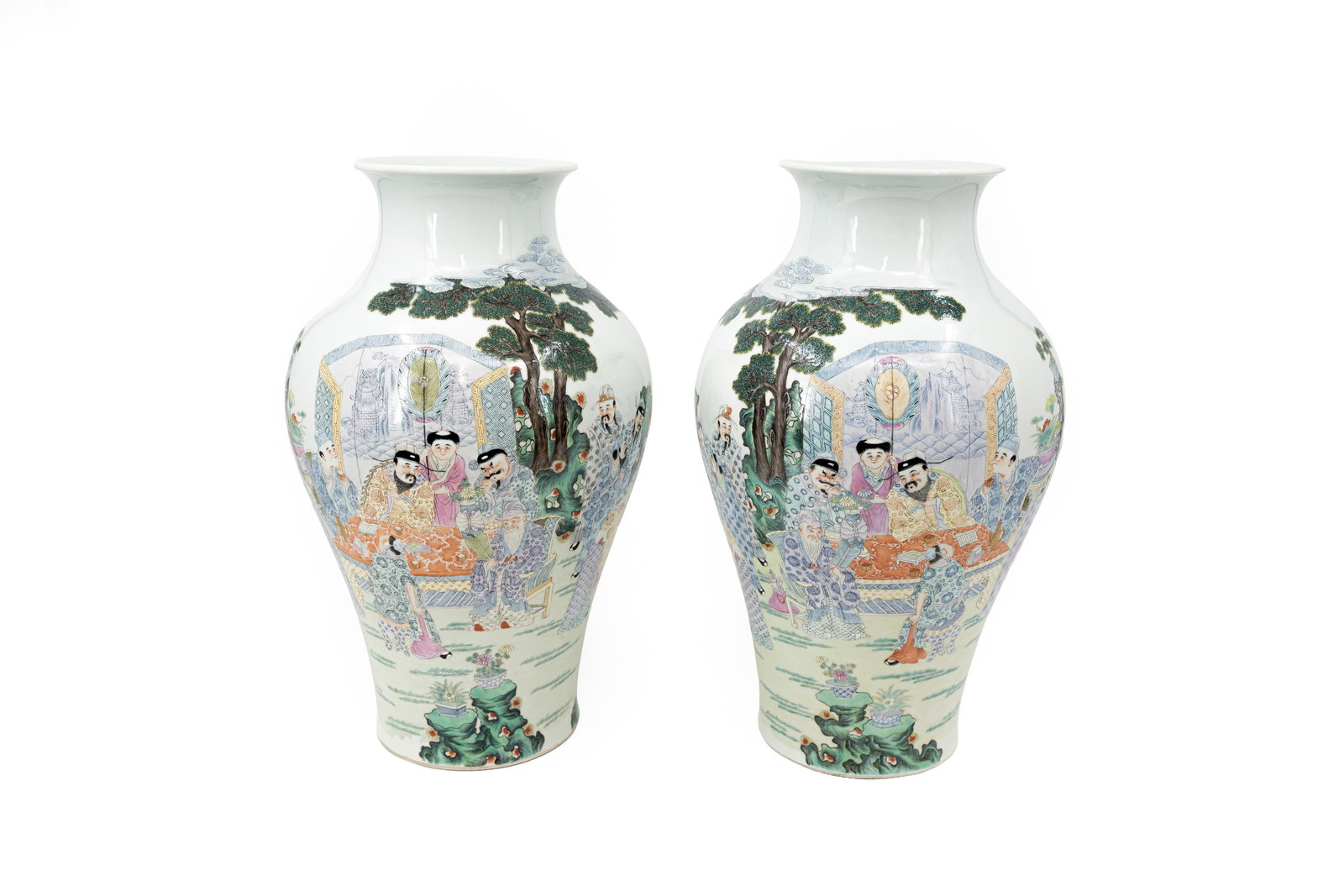 A Chinese pair of Famille rose two-side finely decorated porcelain vases: A Chinese pair of Famille rose two-side finely decorated porcelain vases with the decor of immortals at the table scene. Red seal bottom mark. 19th century. Condition: one small star shaped crack of a