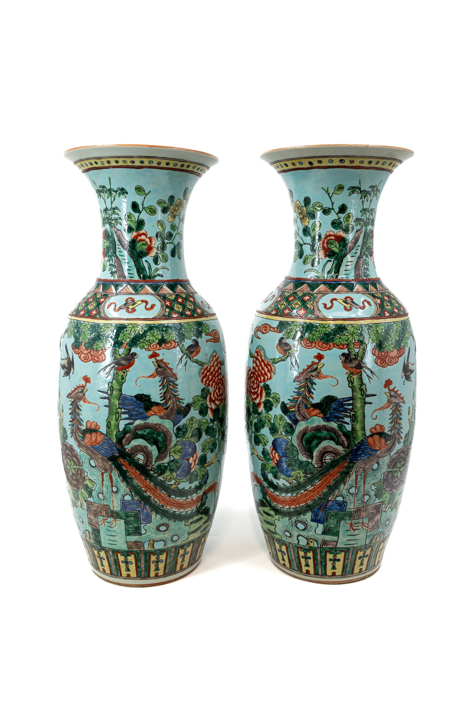 A pair of Chinese Famille verte decorated on a turquoise background porcelain vases: A pair of Chinese Famille verte decorated on a turquoise background porcelain vases with an pheasant scene in a floral decor. 19th century. Condition: both vases are excellent. H: 57,5 cm