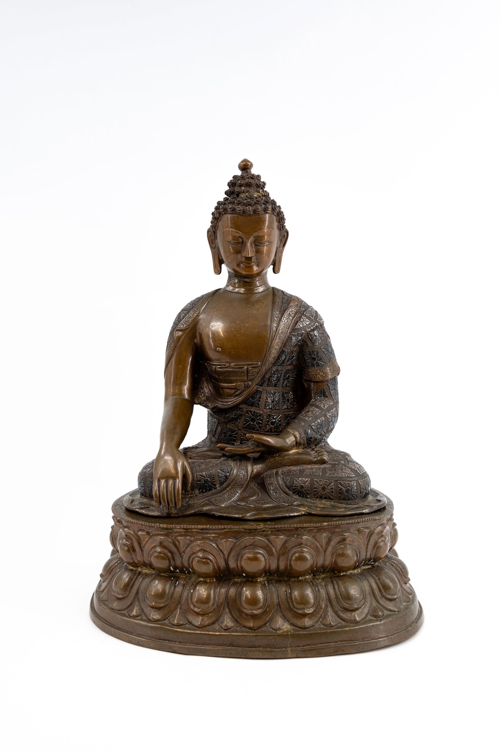 A large and Tibetan decorated and patinated bronze Buddha figure of Shakyamuni: A large and Tibetan decorated and patinated bronze Buddha figure of Shakyamuni. 19th/20th century. H: 47 - W: 36 cm