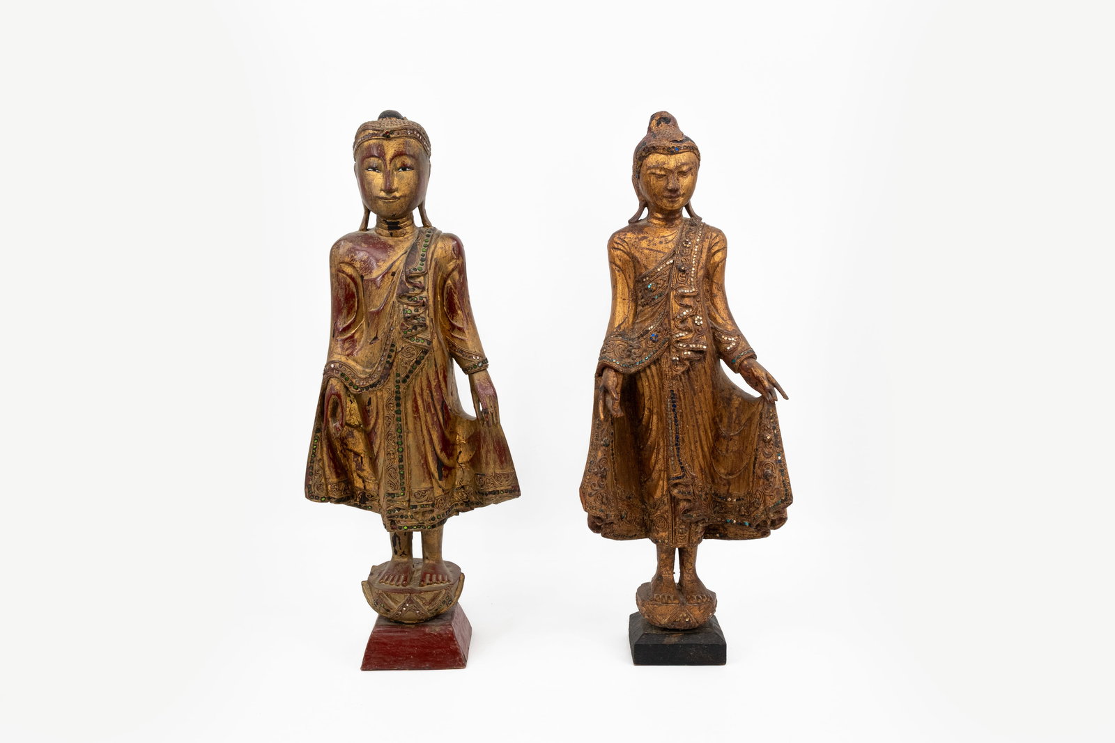 A composed lot of two Thai polychrome carved wood sculptures of standing Buddha's (1 of 17)