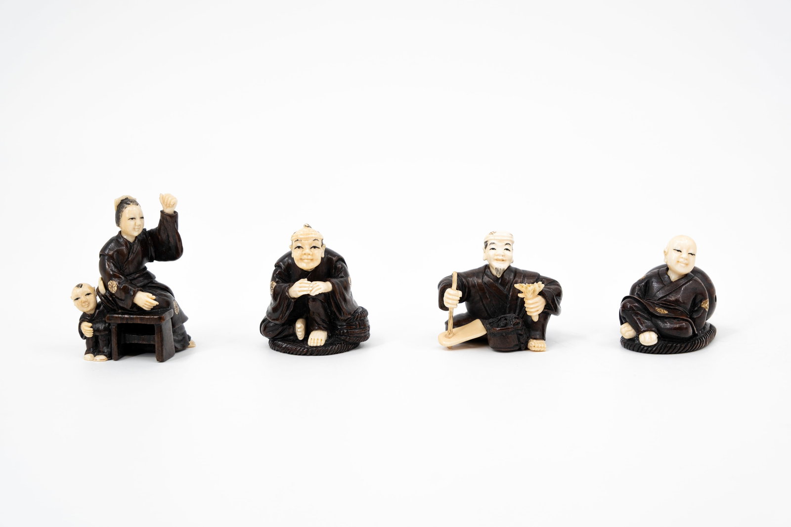 A lot of four Japanese carved wood and ivory netsukes: A lot of four Japanese carved wood and ivory netsukes. Bottom has red seal mark. Late Meiji, early 20th century. Comes with European Cites document, for EU shipping only. With number 2026/BE00726/CE.