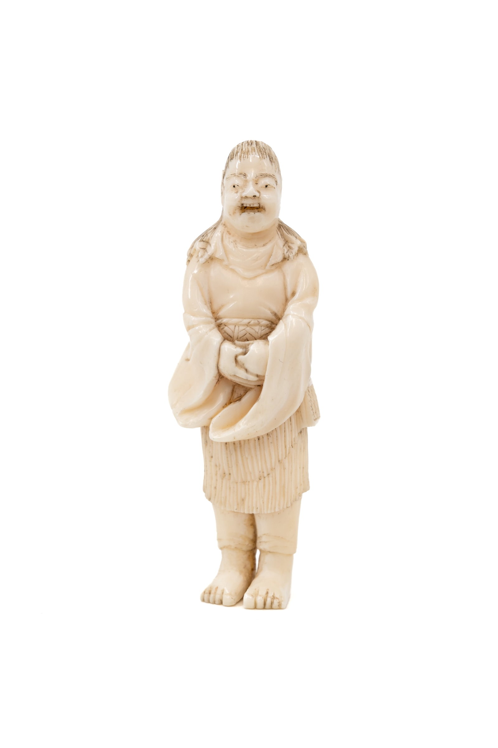 An antique Japanese carved ivory netsuke figurine sculpture of a standing man (1 of 7)