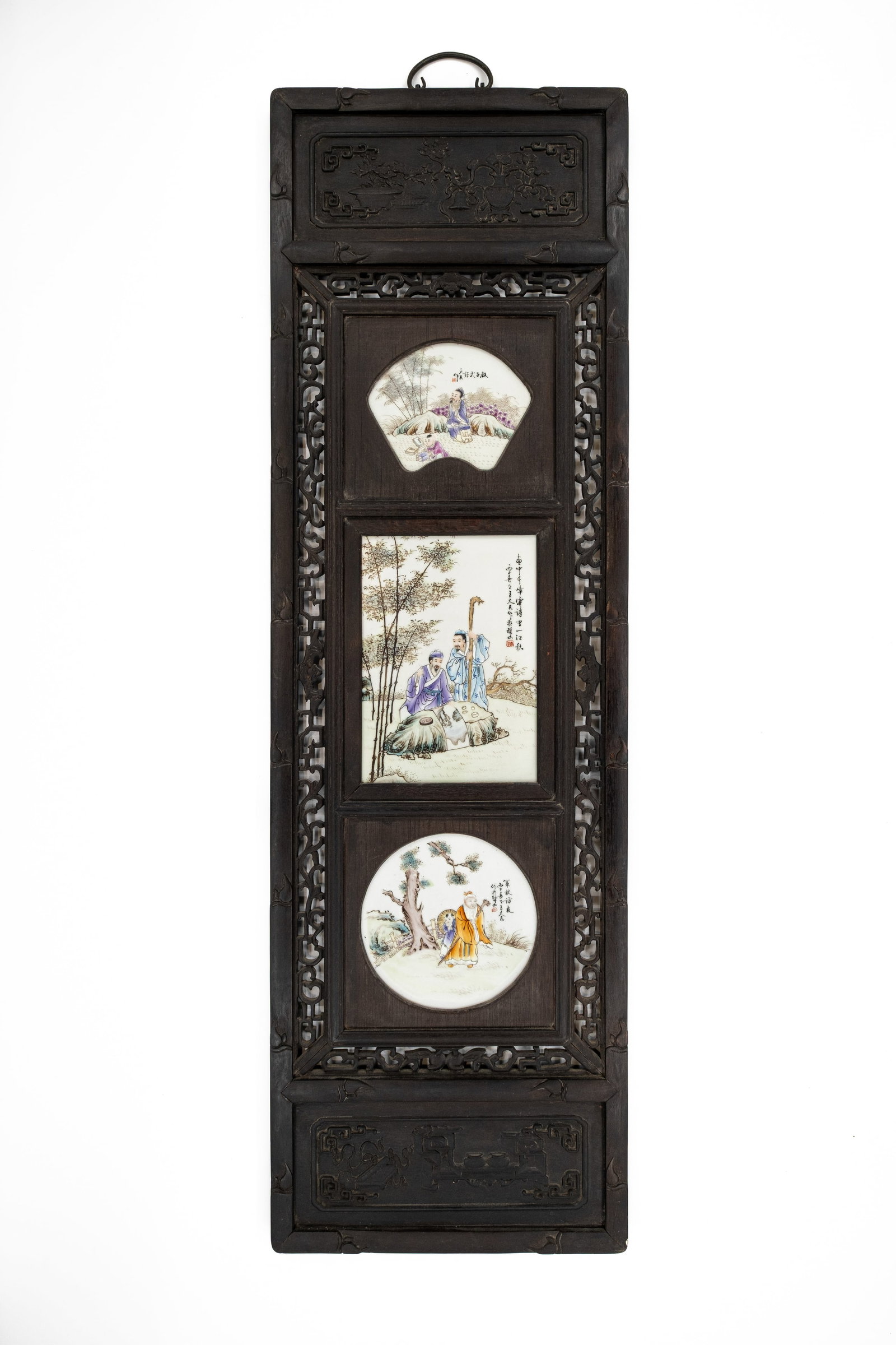 A Chinese Famille rose republic decorated porcelain plaques mounted in a carved hardwood frame: A Chinese Famille rose republic decorated porcelain plaques mounted in a carved exotic hardwood wall frame. 20th century.