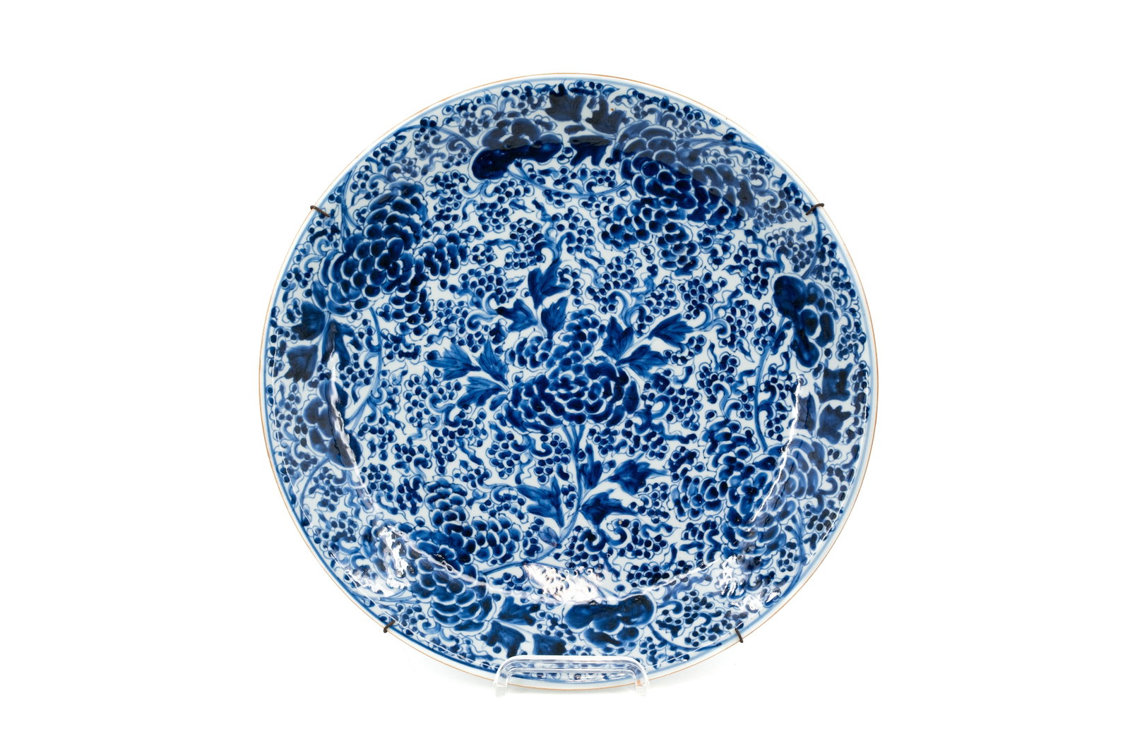 A large Chinese finely blue and white floral decorated porcelain dish: A large Chinese finely blue and white floral decorated porcelain dish. Kangxi mark, 18th century. Condition: two very small rim chip, otherwise dish is in excellent condition. Report available on requ
